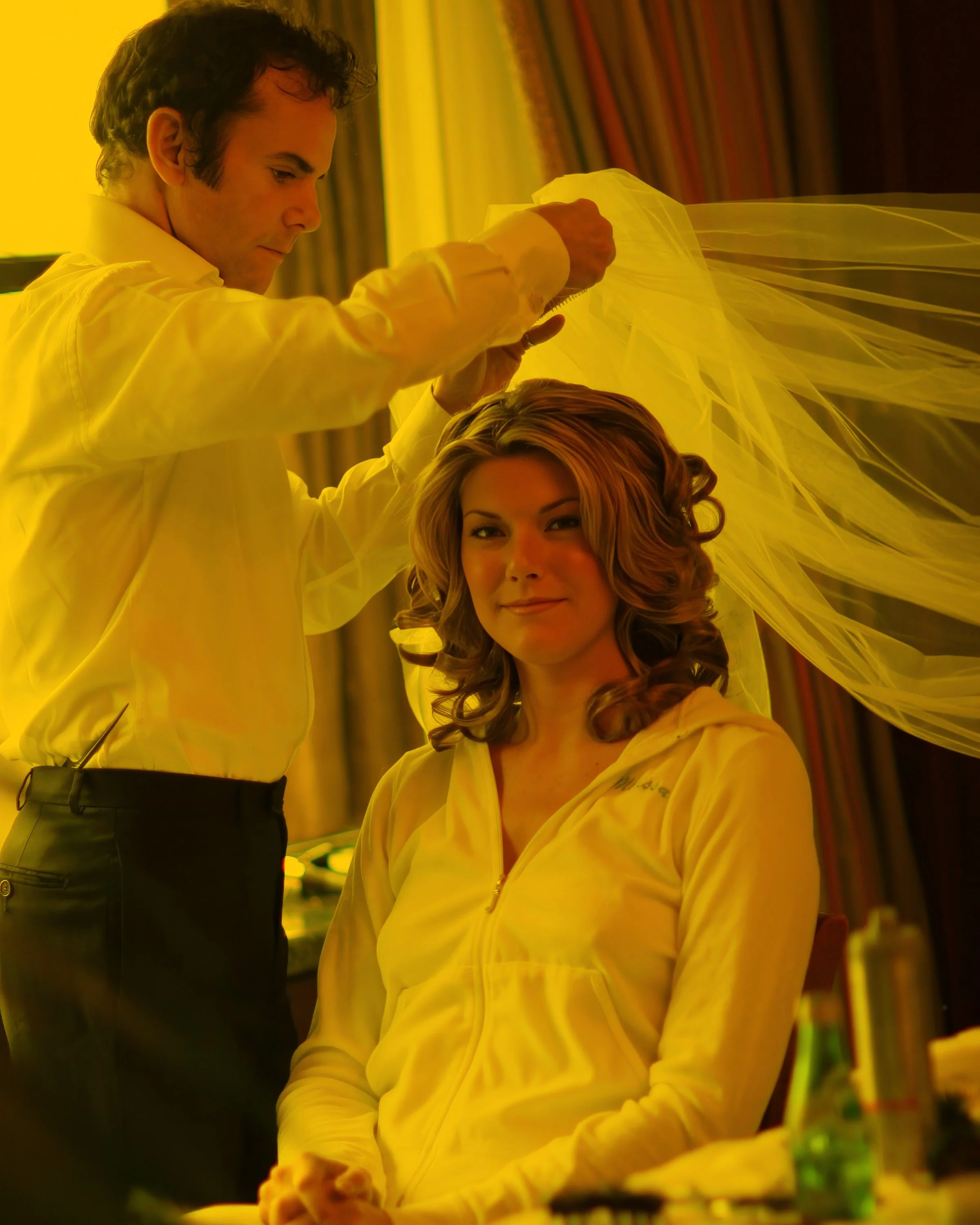 The bride puts on her veil in her suite at the New York Palace Hotel