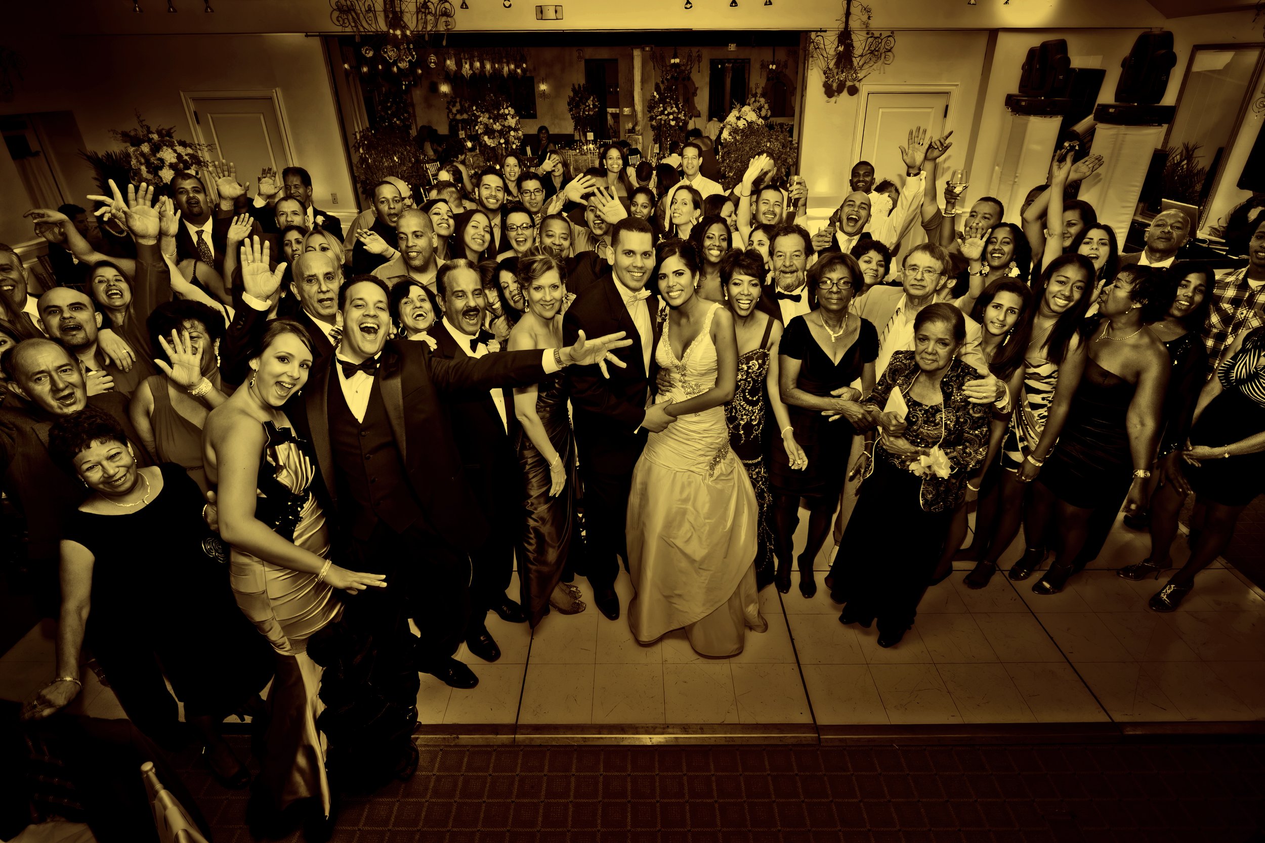 Large group of wedding guests pose on the dance floor at Delamar Greenwich Harbor.