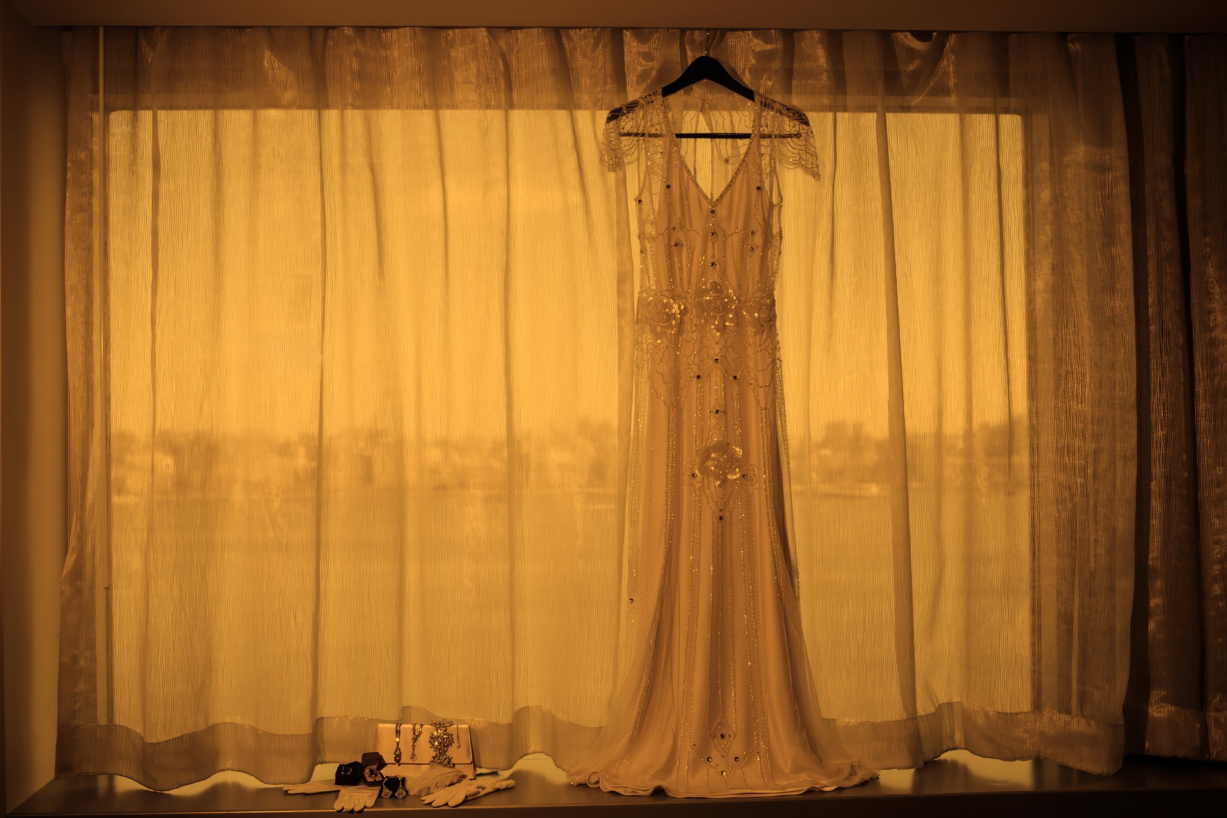 Wedding dress hanging elegantly in the bridal suite at W Hoboken before the celebration begins.