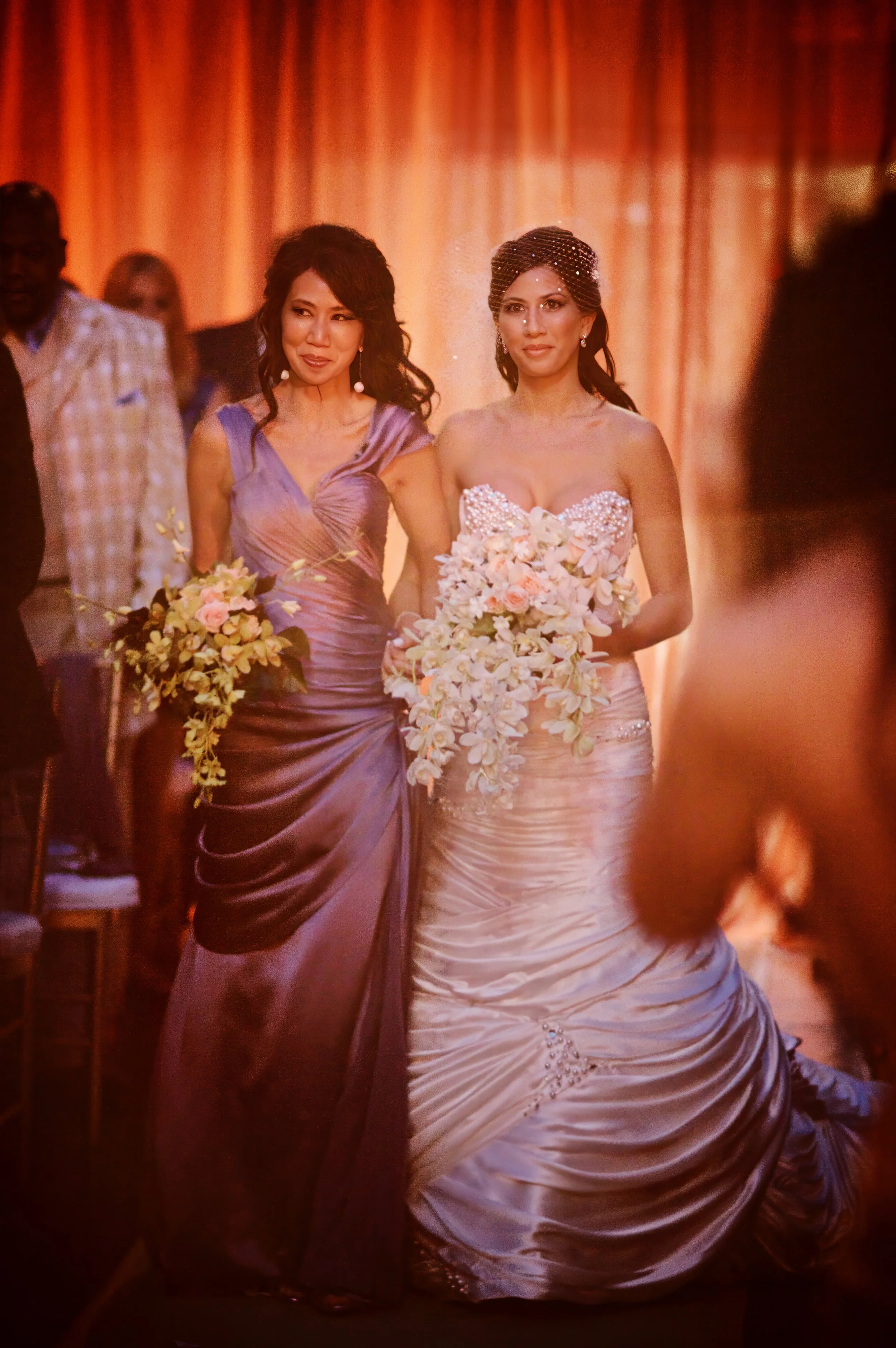 A bride walks down the aisle with her mother during a wedding ceremony at Angel Orensanz in New York City.