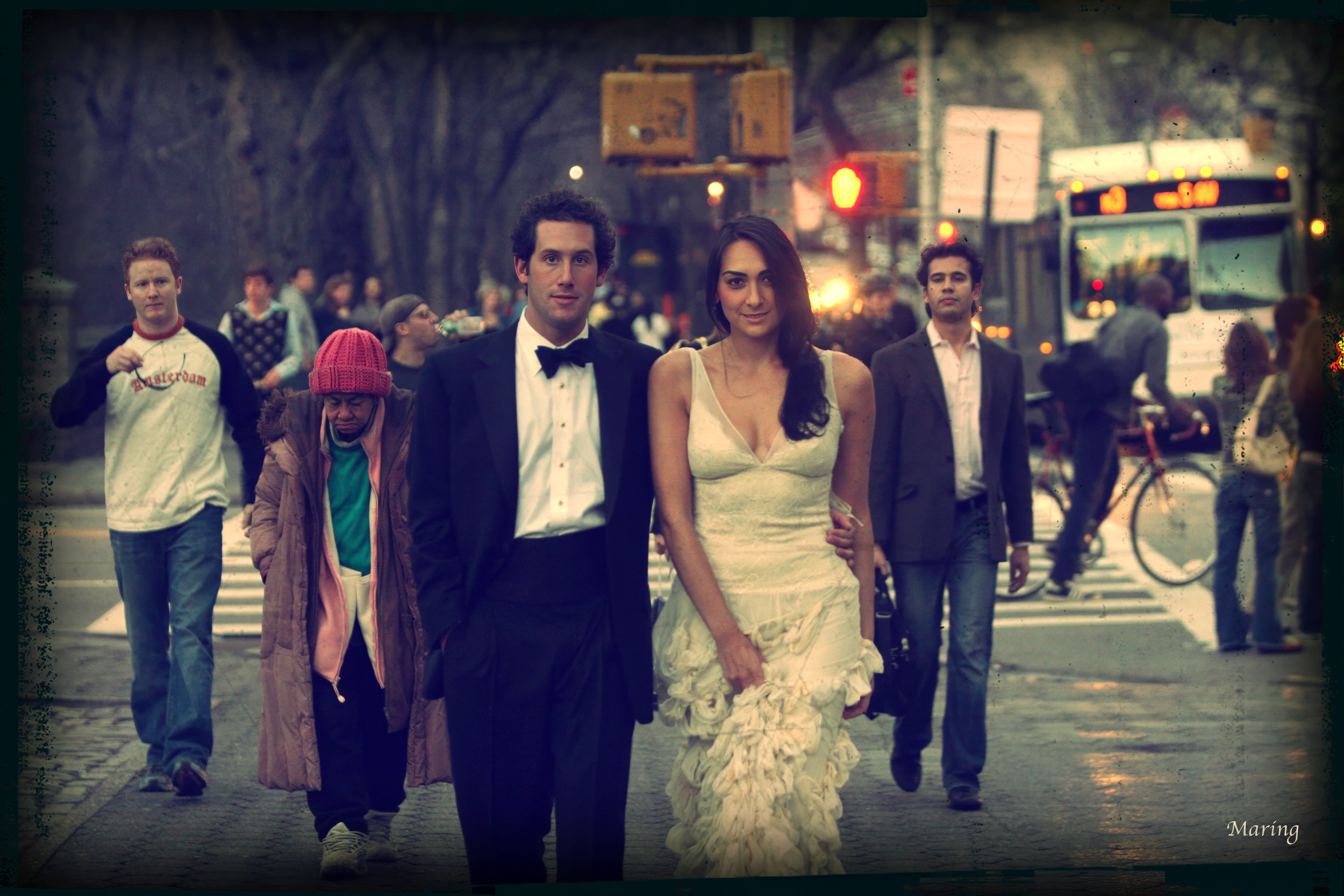 Bride and Groom walk towards the entrance of Central Park on 5th Avenue NYC