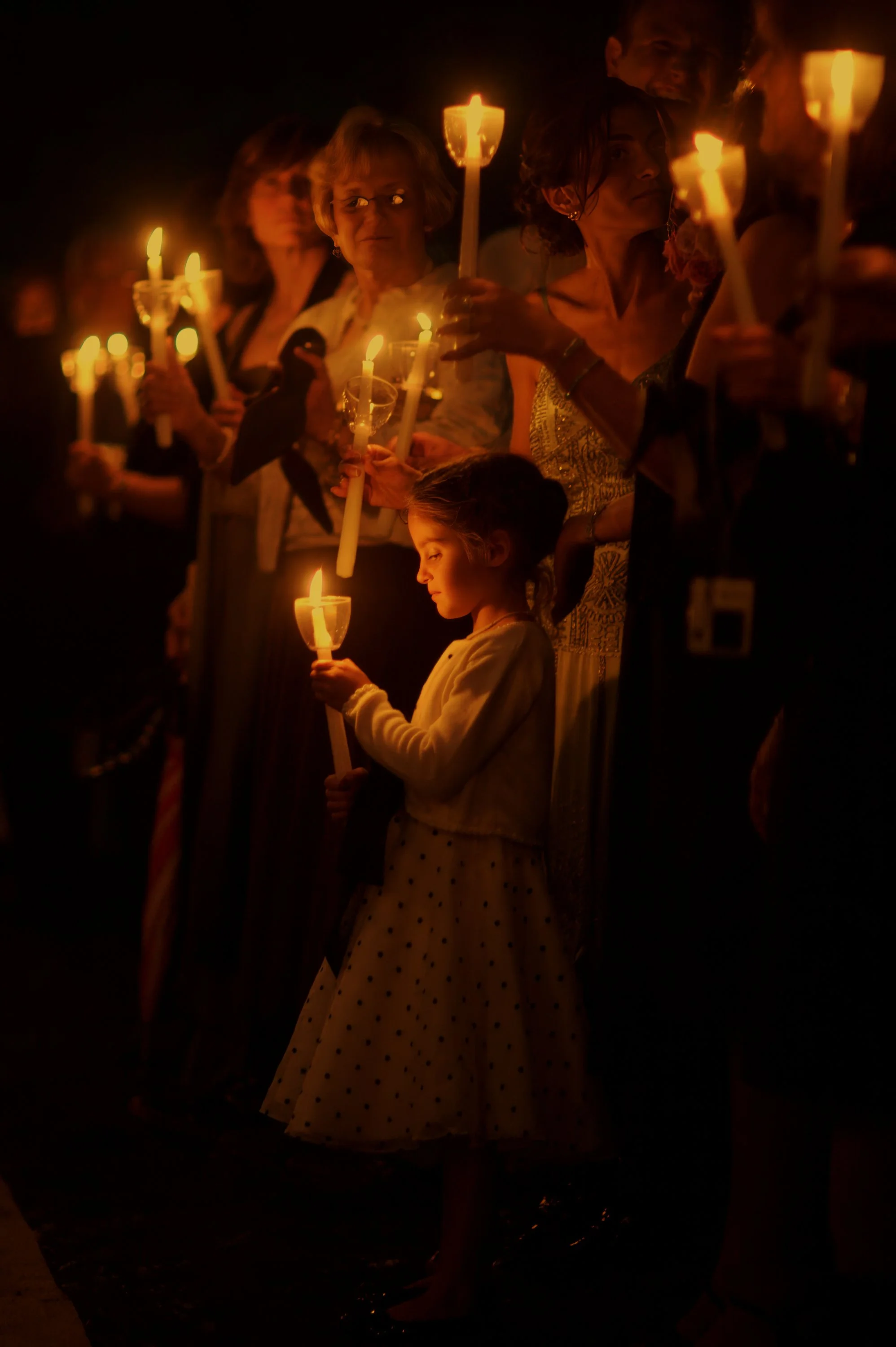 Flower girl holding a candle while waiting for the bride at an estate wedding in East Haddam Connecticut.