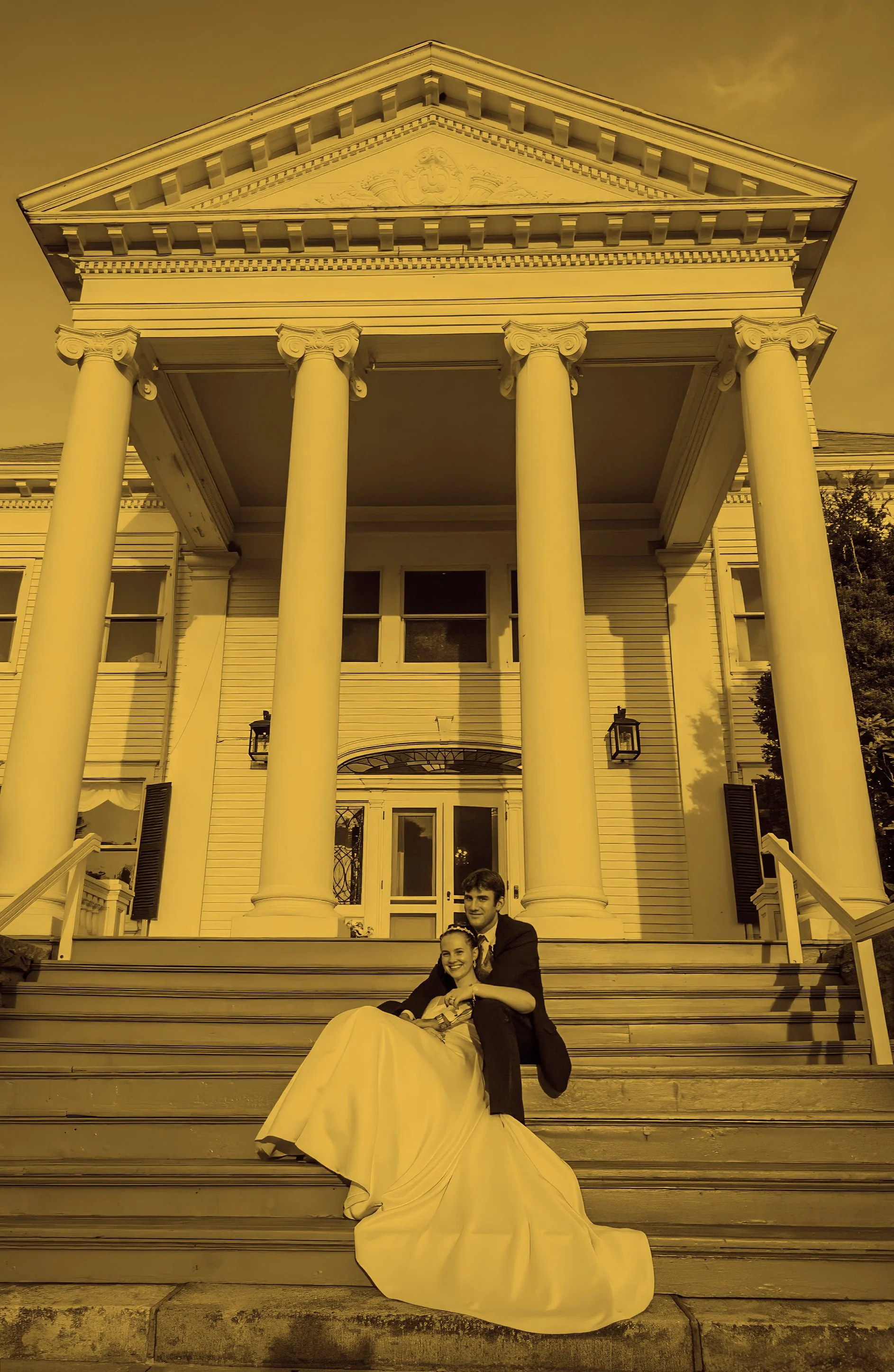 Bride and groom portrait on mansion porch with columns at Inn at Mystic Connecticut wedding photographer