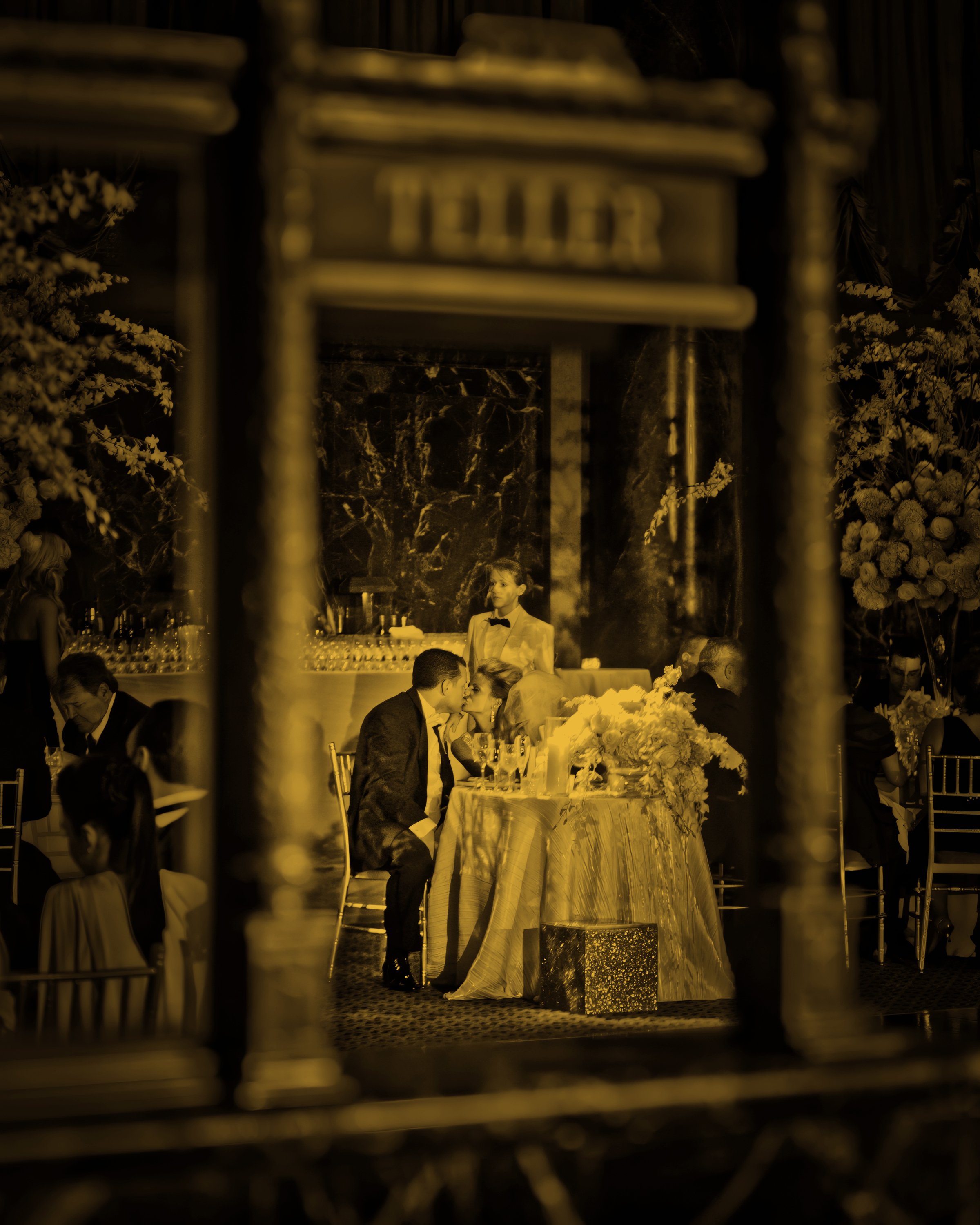 Bride and Groom Kiss at Sweetheart Table During Cipriani 42nd Street Wedding Reception