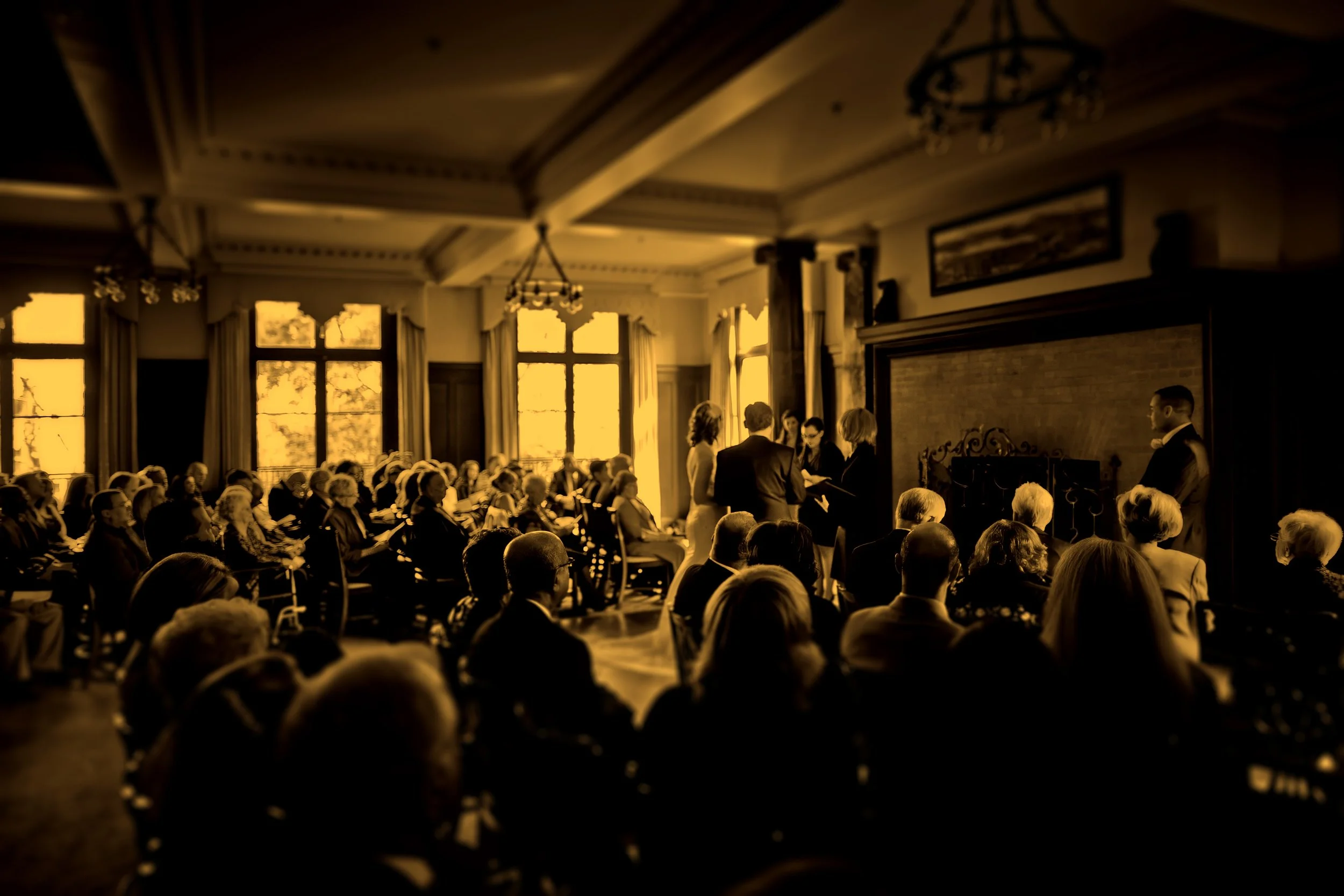 Wide angle fine art photograph of a wedding ceremony inside Union League Cafe.