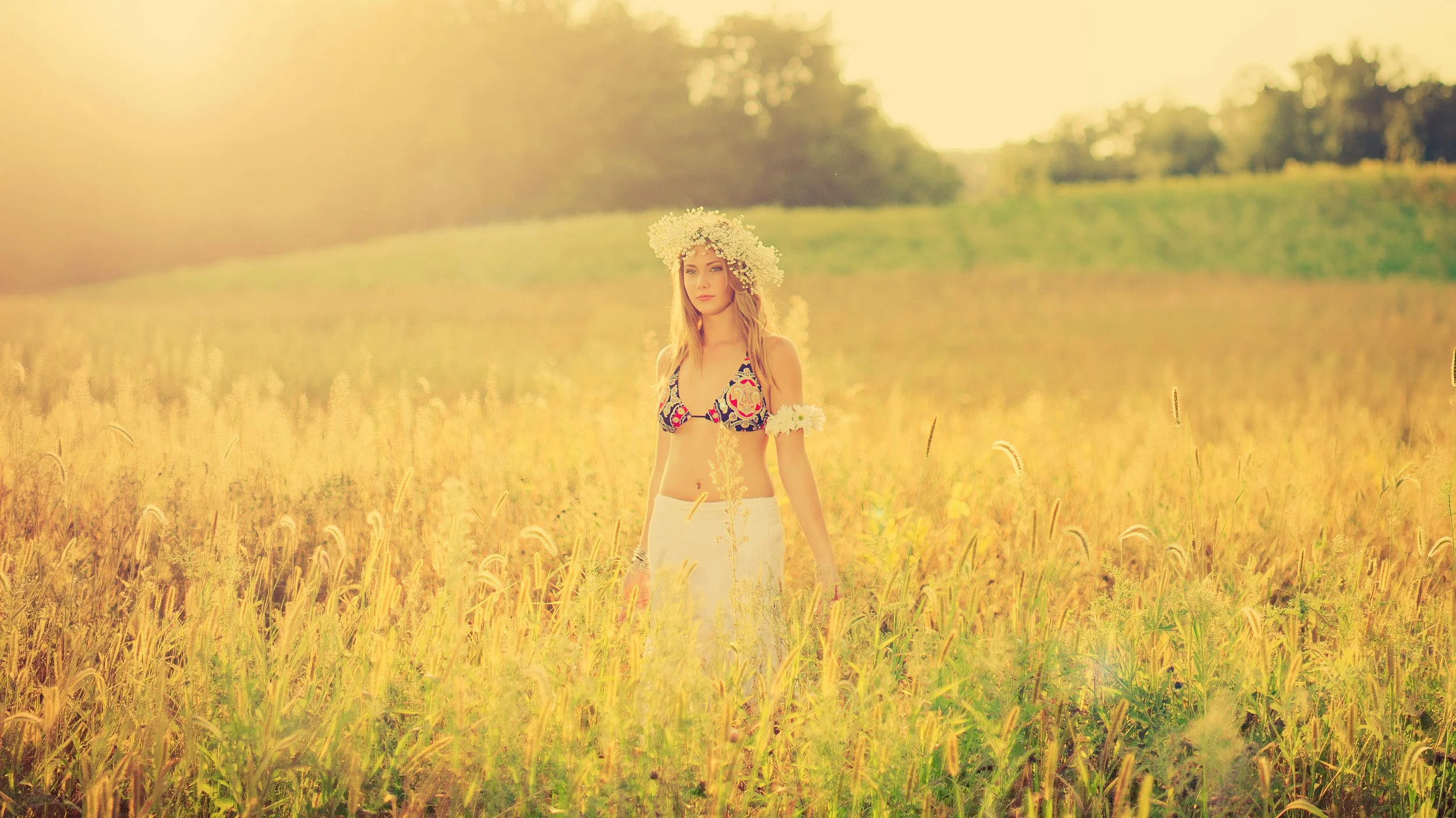Model in stylized freedom-inspired photoshoot in fields of gold
