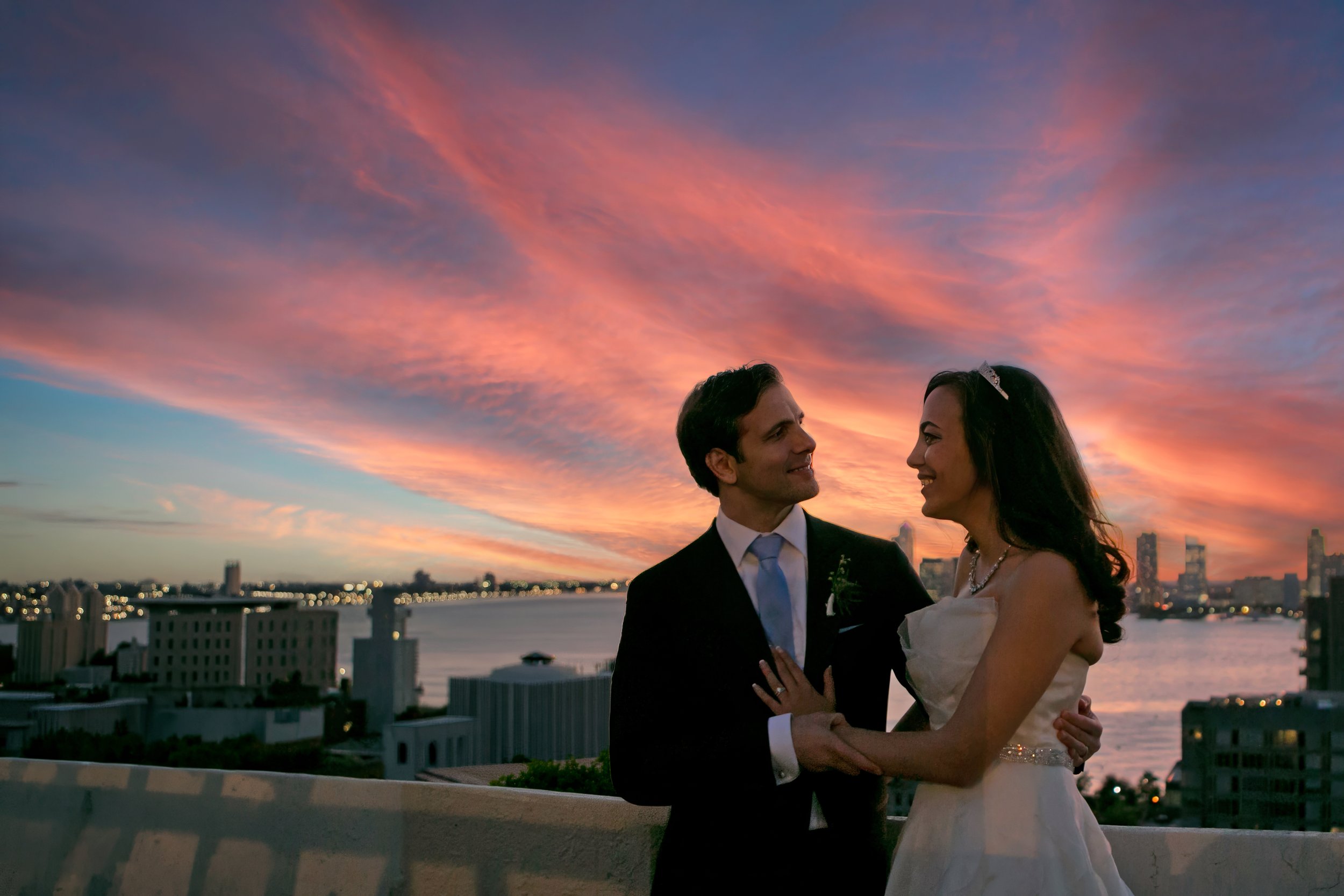 Bride and groom watching the sunset together on Tribeca Rooftop with Hudson River views.