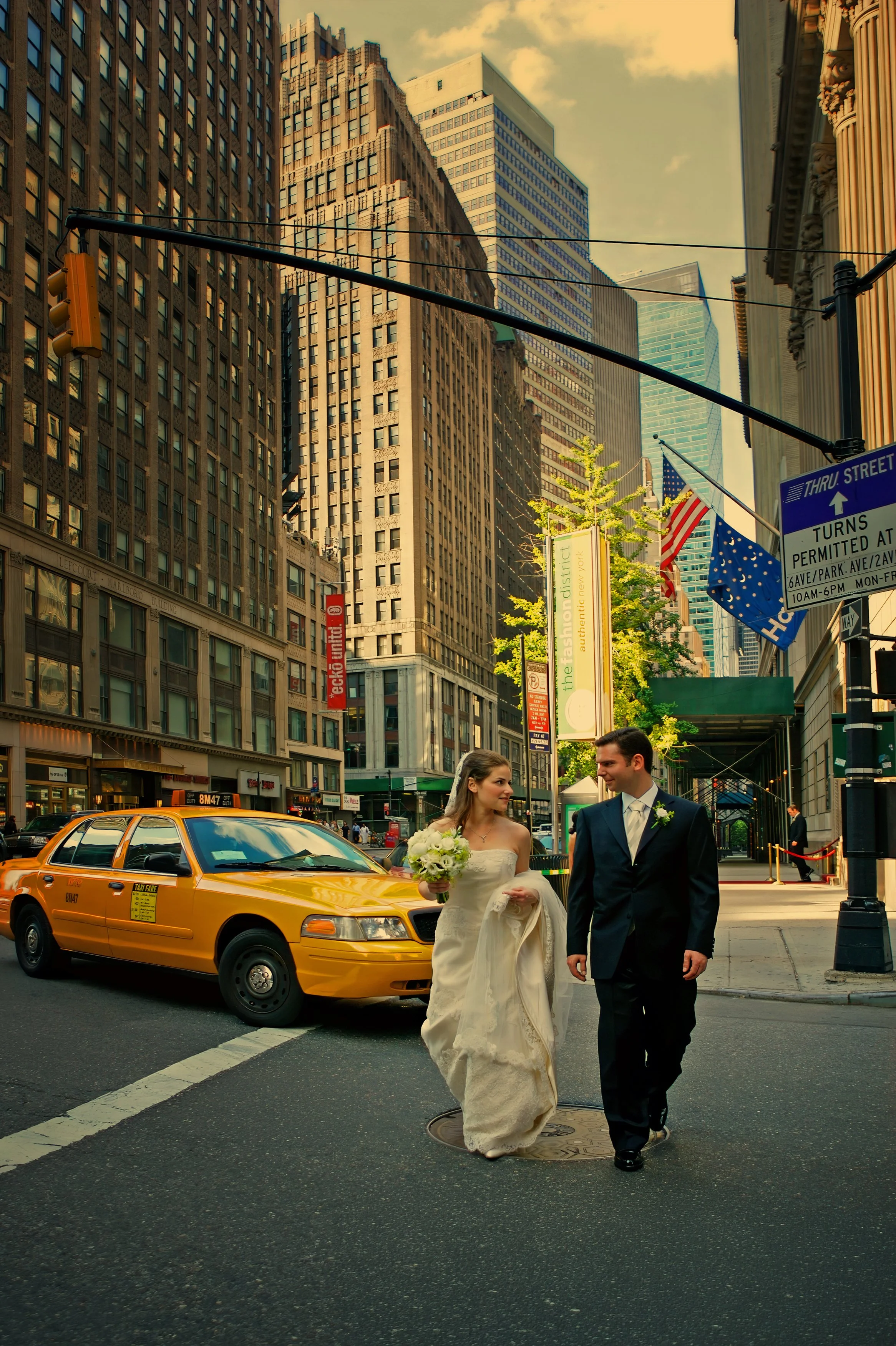 Bride and groom walking together through the streets of Midtown Manhattan during their NYC wedding day.