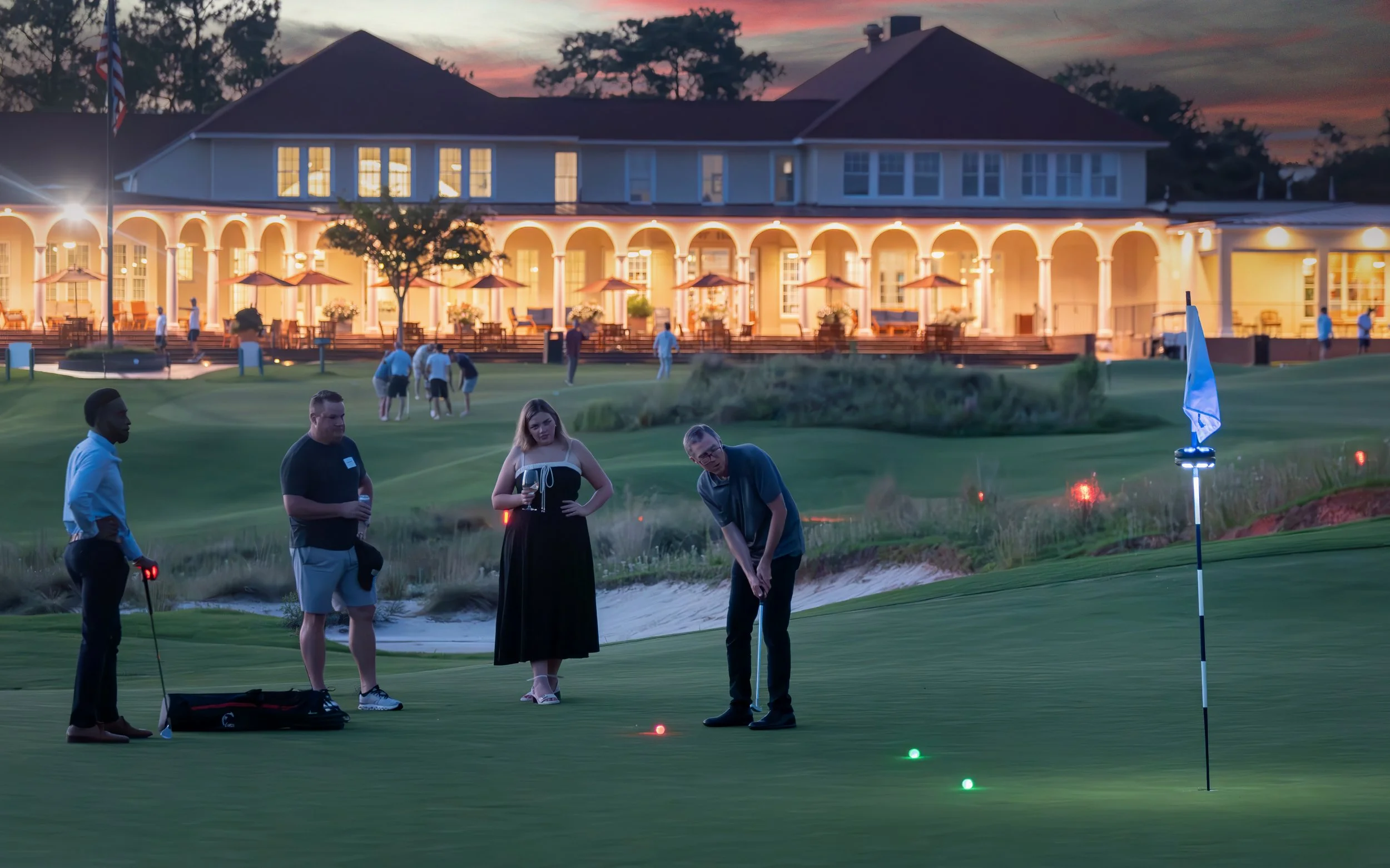 Corporate team participating in glow-in-the-dark golf activity during an executive retreat