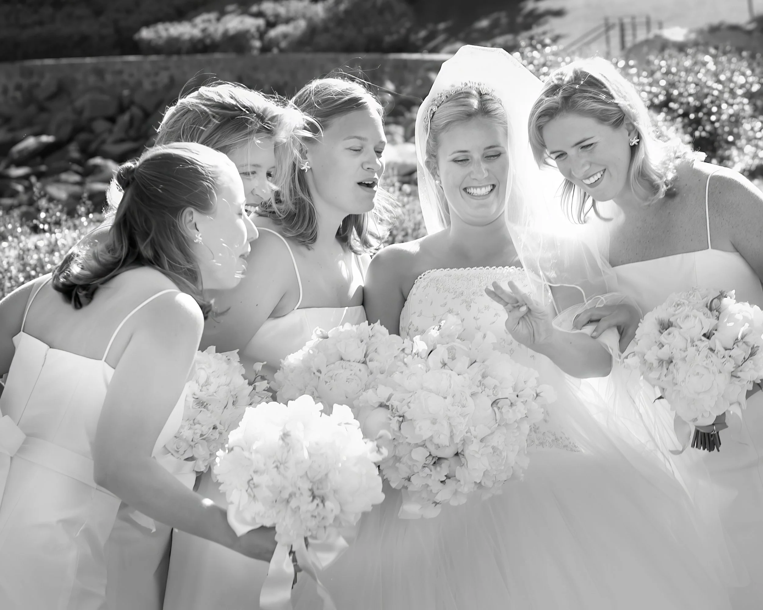 Bridesmaids sharing a joyful moment together at Belle Haven Yacht Club wedding celebration.