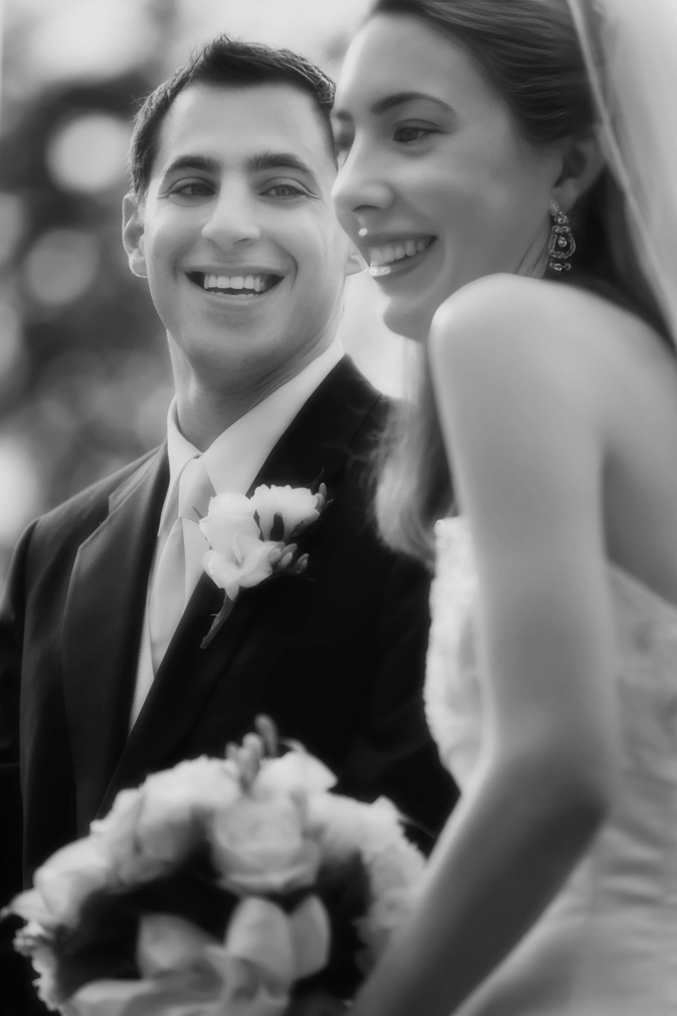 Groom gazes lovingly at the bride during their wedding ceremony at Le Chateau