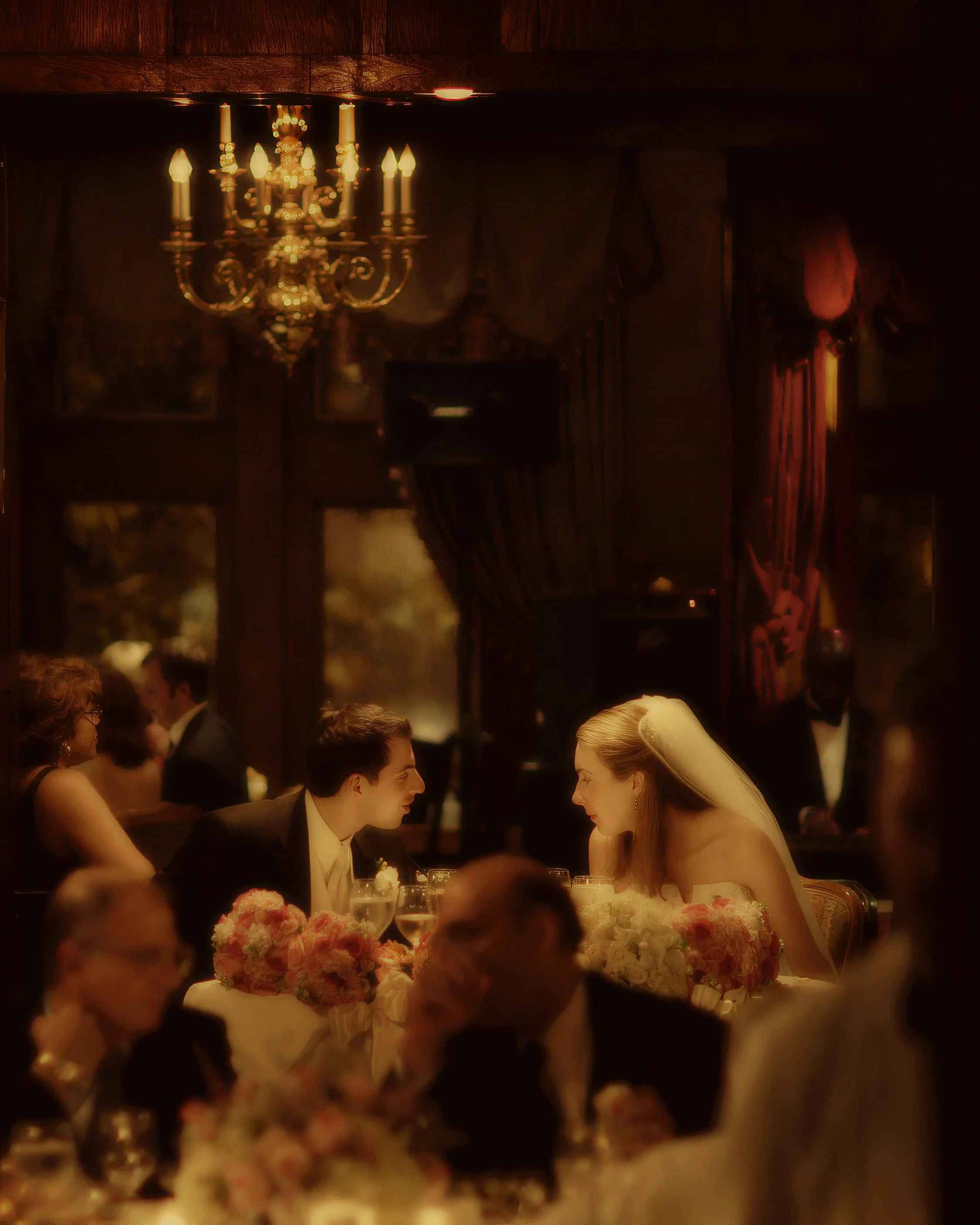 Bride and groom share a romantic candlelit dinner conversation at Le Chateau