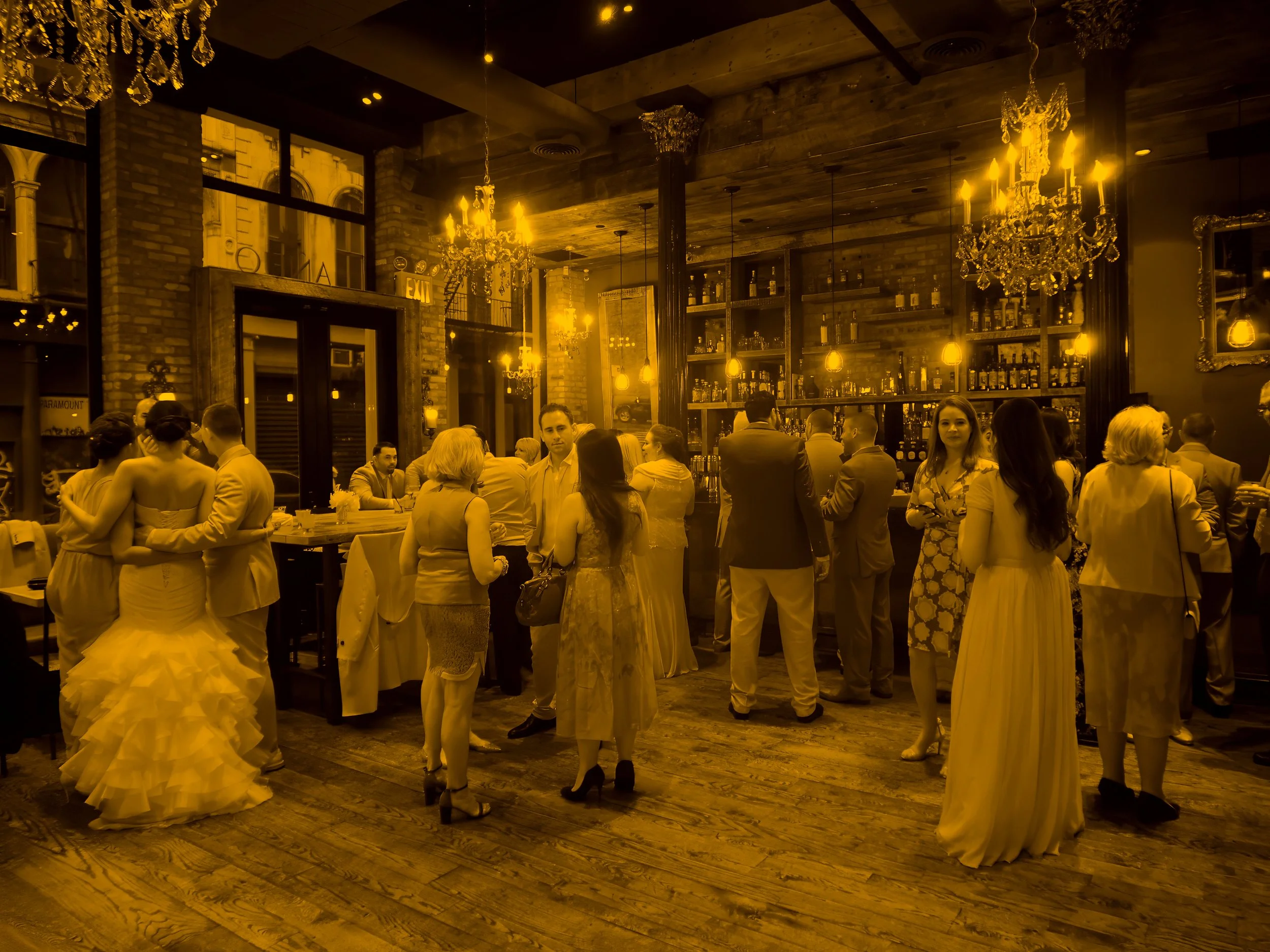 Wedding guests mingle and converse during a restaurant wedding reception at Añejo in NYC.