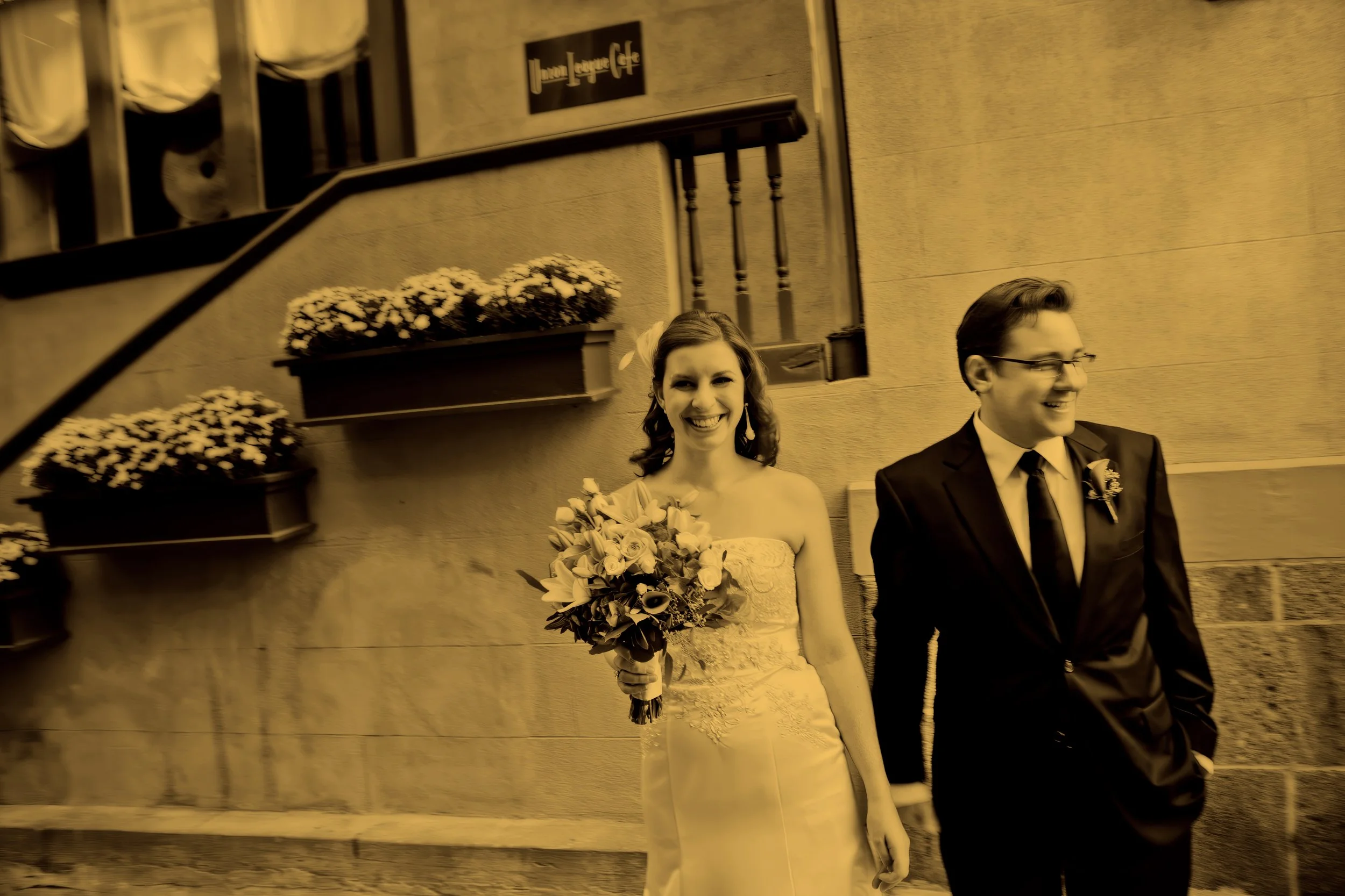 Candid moment of the bride and groom laughing outside Union League Cafe.