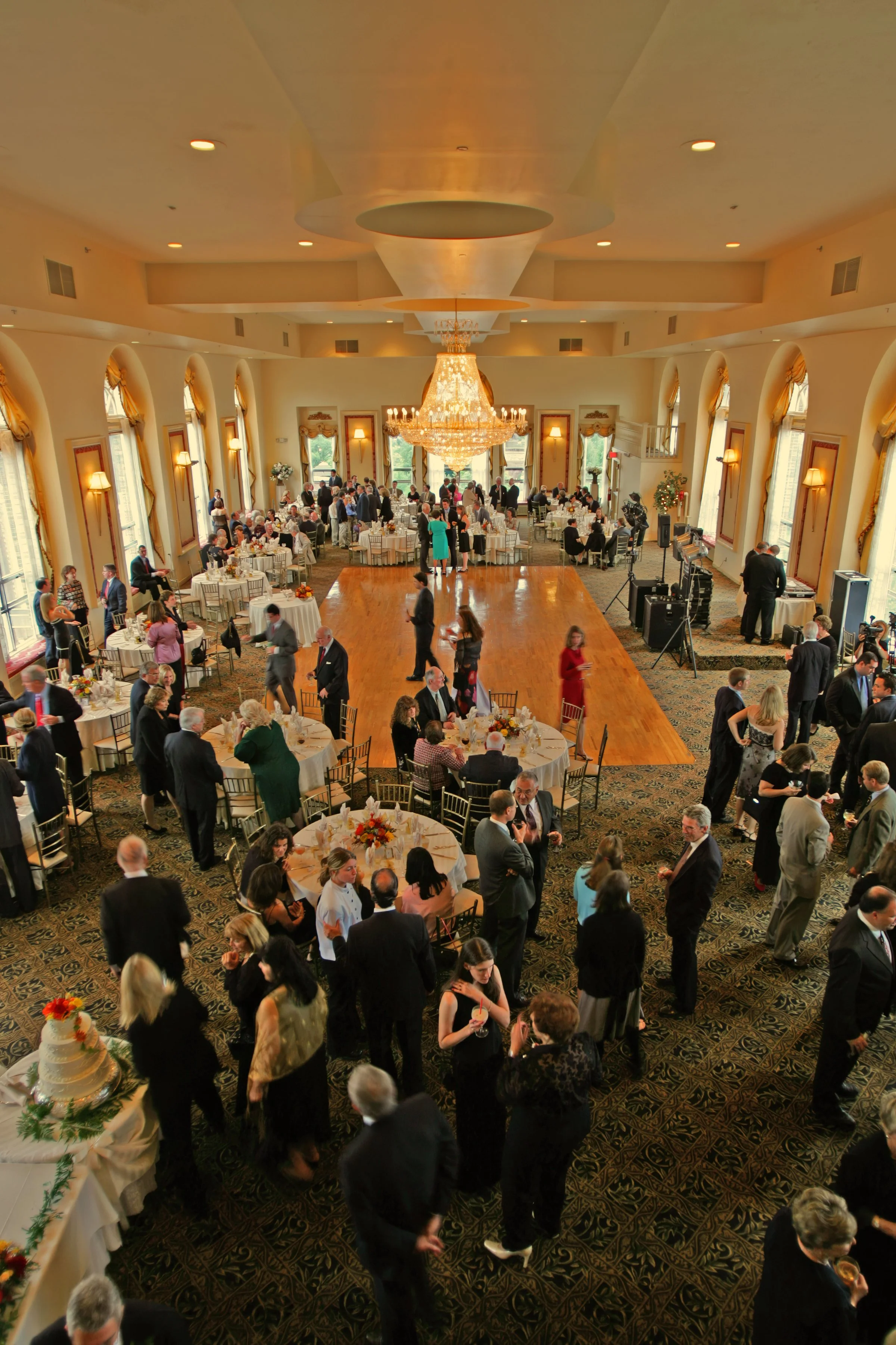 Sweeping view of Bond Ballroom cocktail hour with guests mingling.