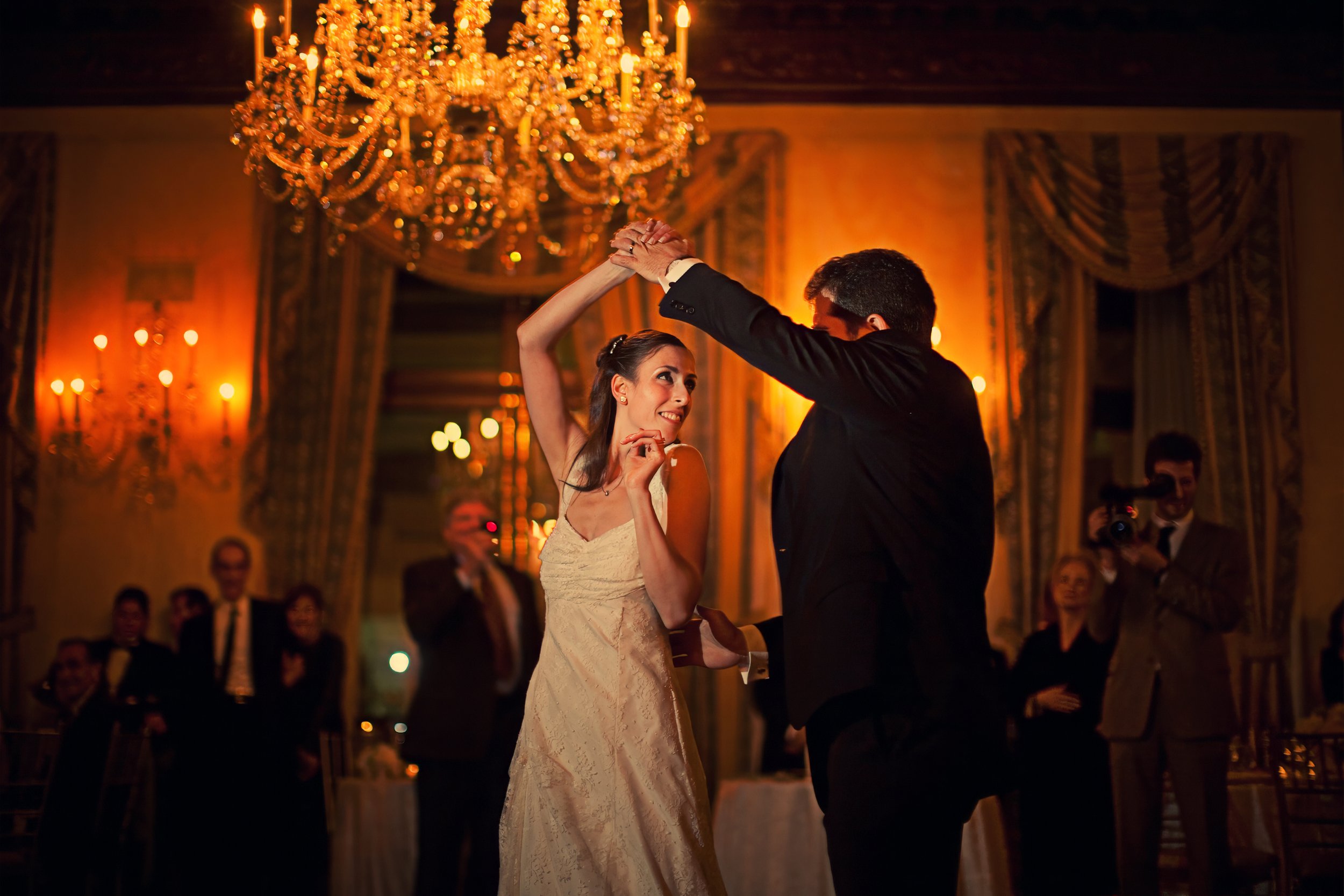 Bride and groom spinning together on the ballroom dance floor at The Harmonie Club New York.