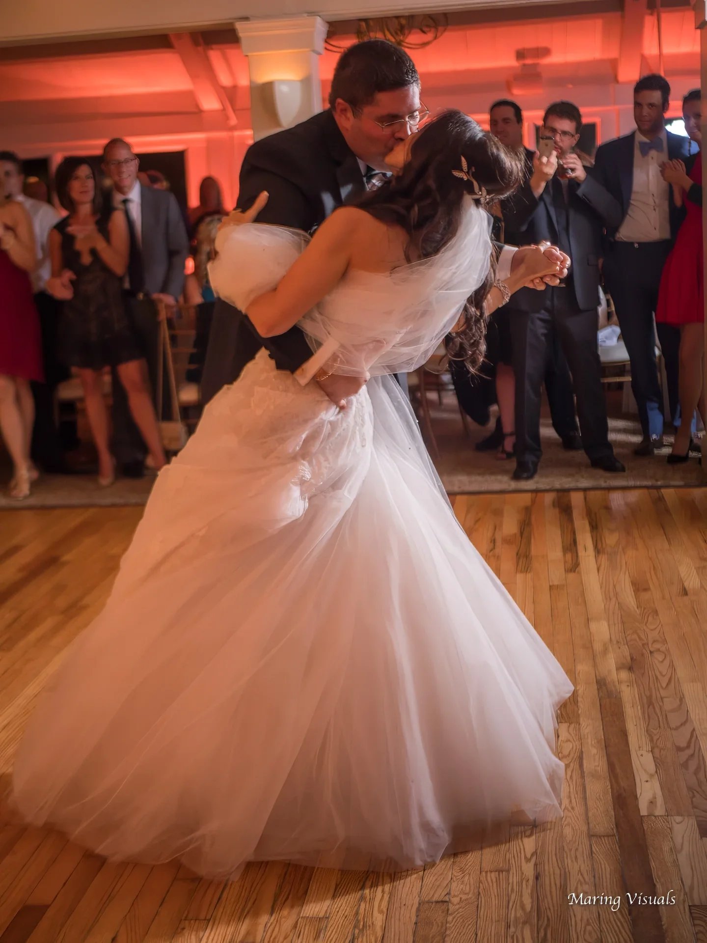 Groom dips the bride during their first dance at Coveleigh Club
