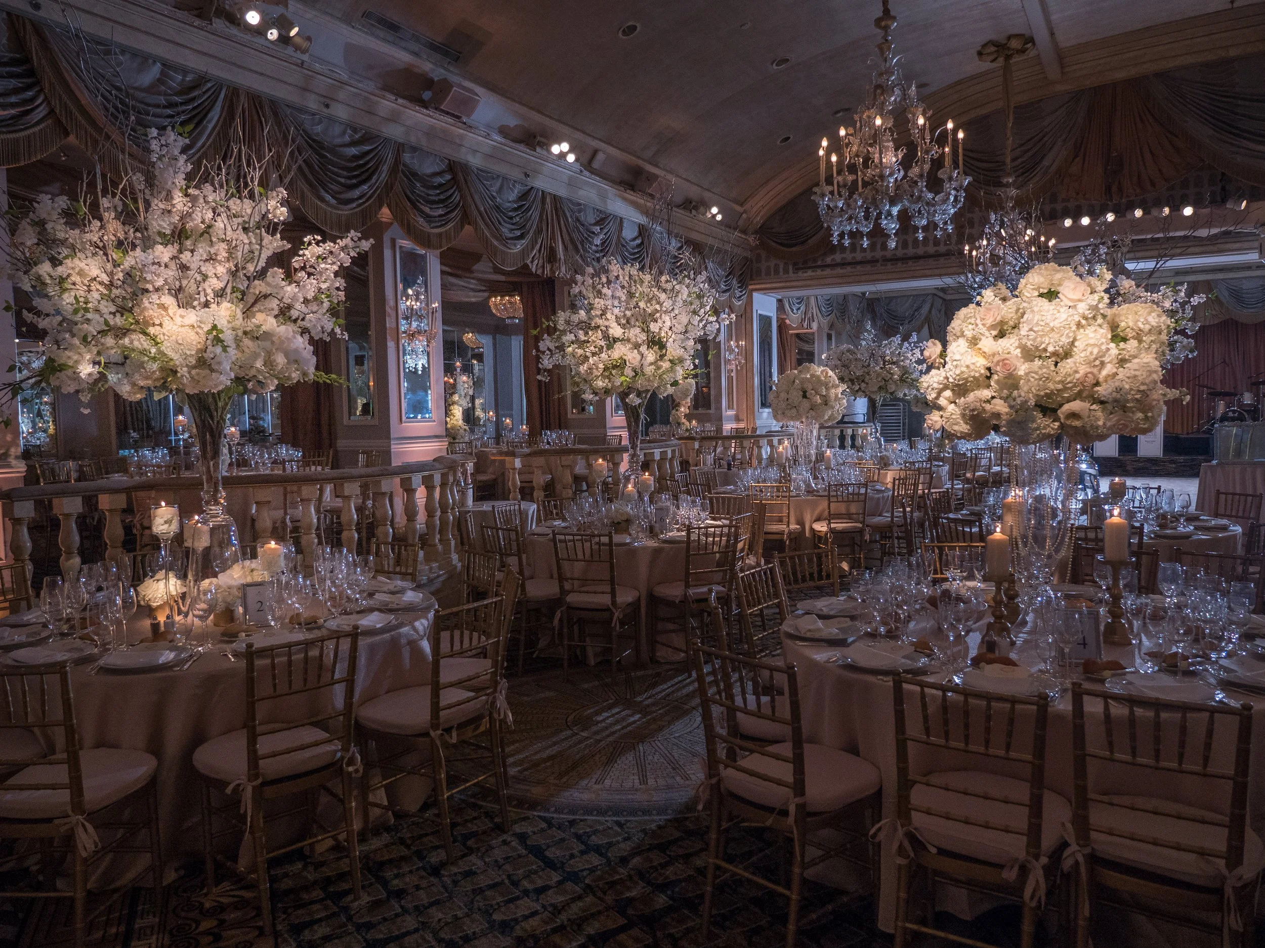 Refined wedding tablescape with muted florals and elegant place settings at a luxury estate celebration