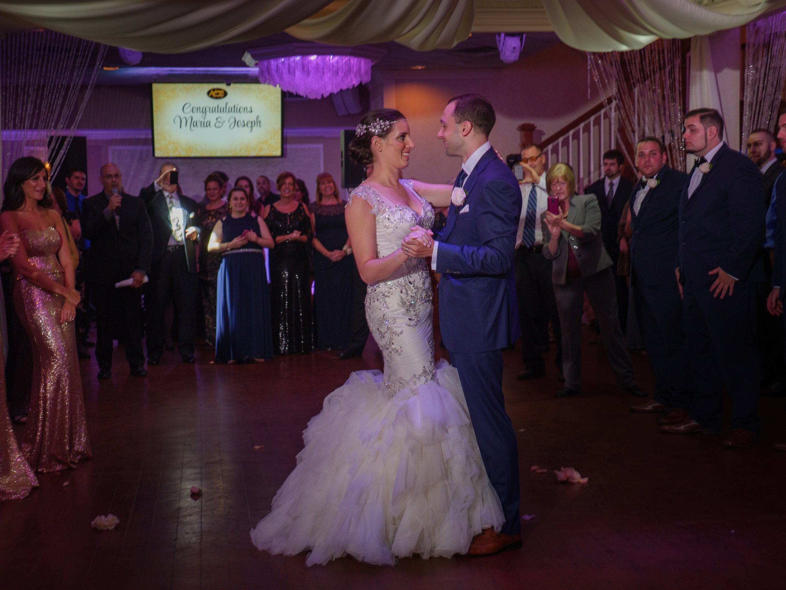 The bride and groom begin their first dance in the ballroom at Anthony's Ocean View