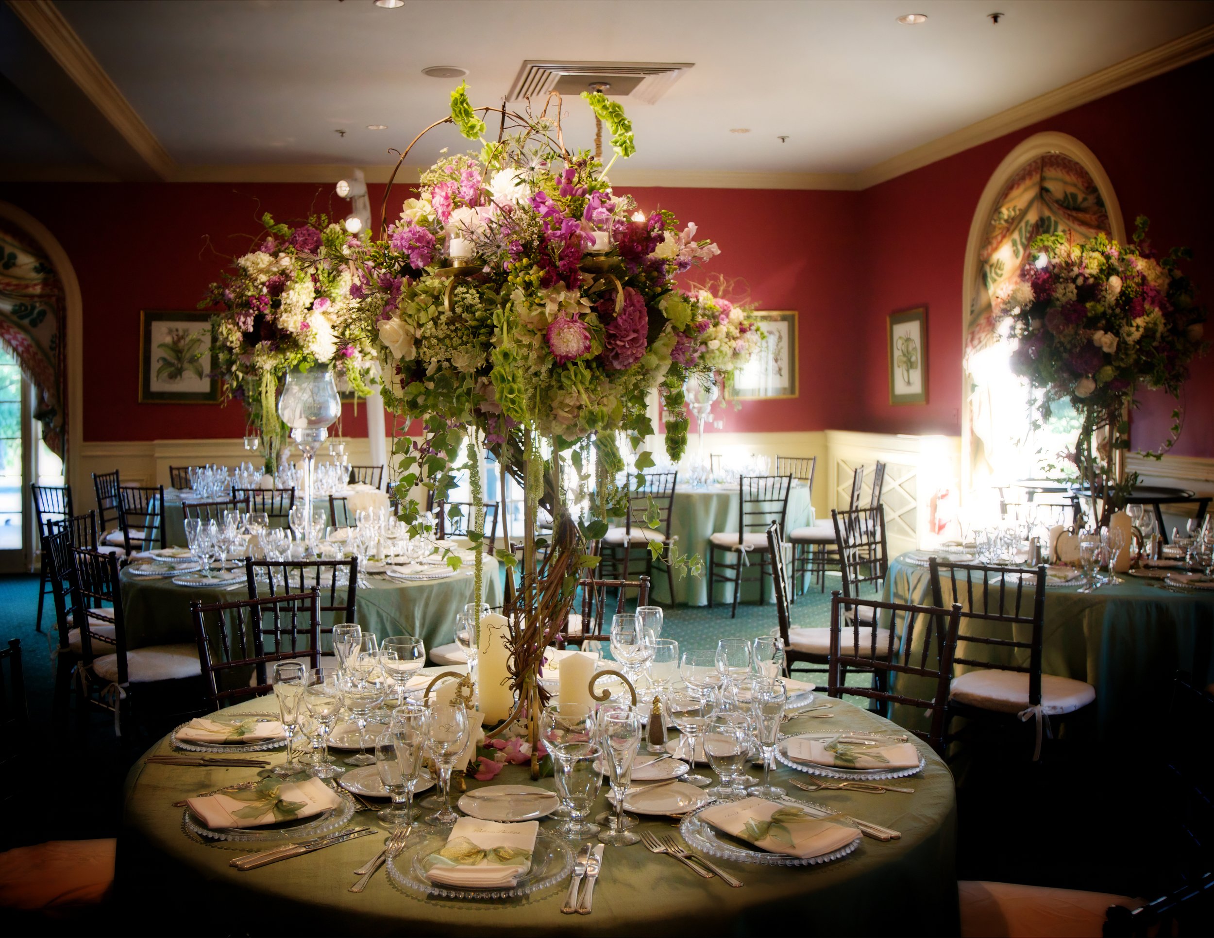 Elegant floral décor arranged inside Siwanoy Country Club for a wedding reception.