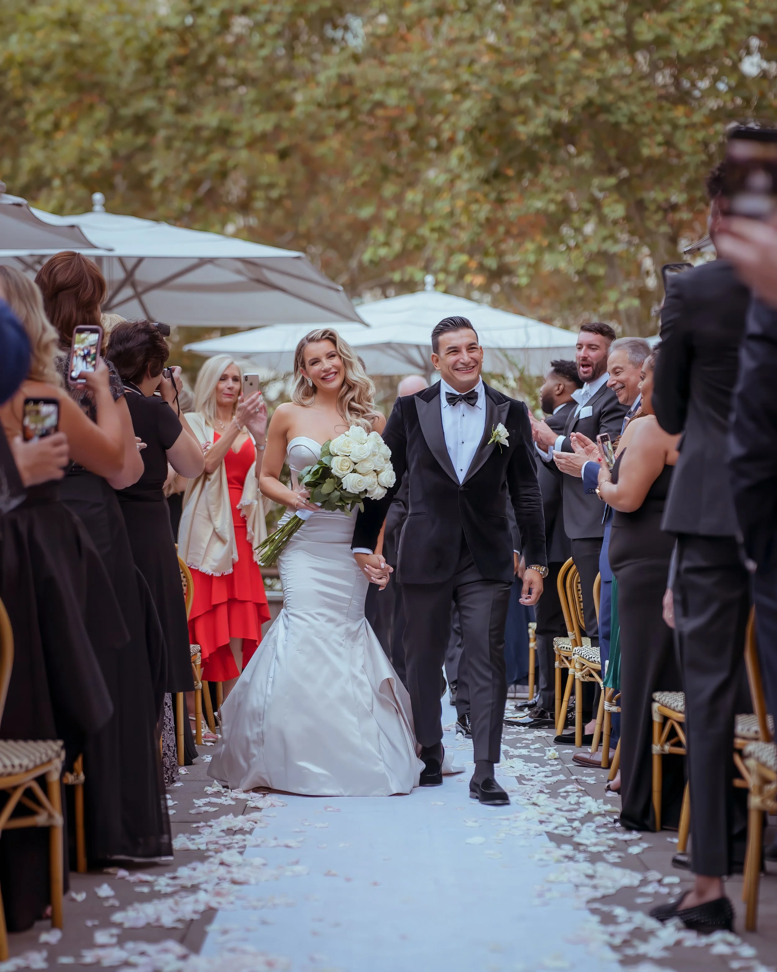 Wedding ceremony recessional on the terrace at Bryant Park Grill with guests celebrating in Midtown Manhattan