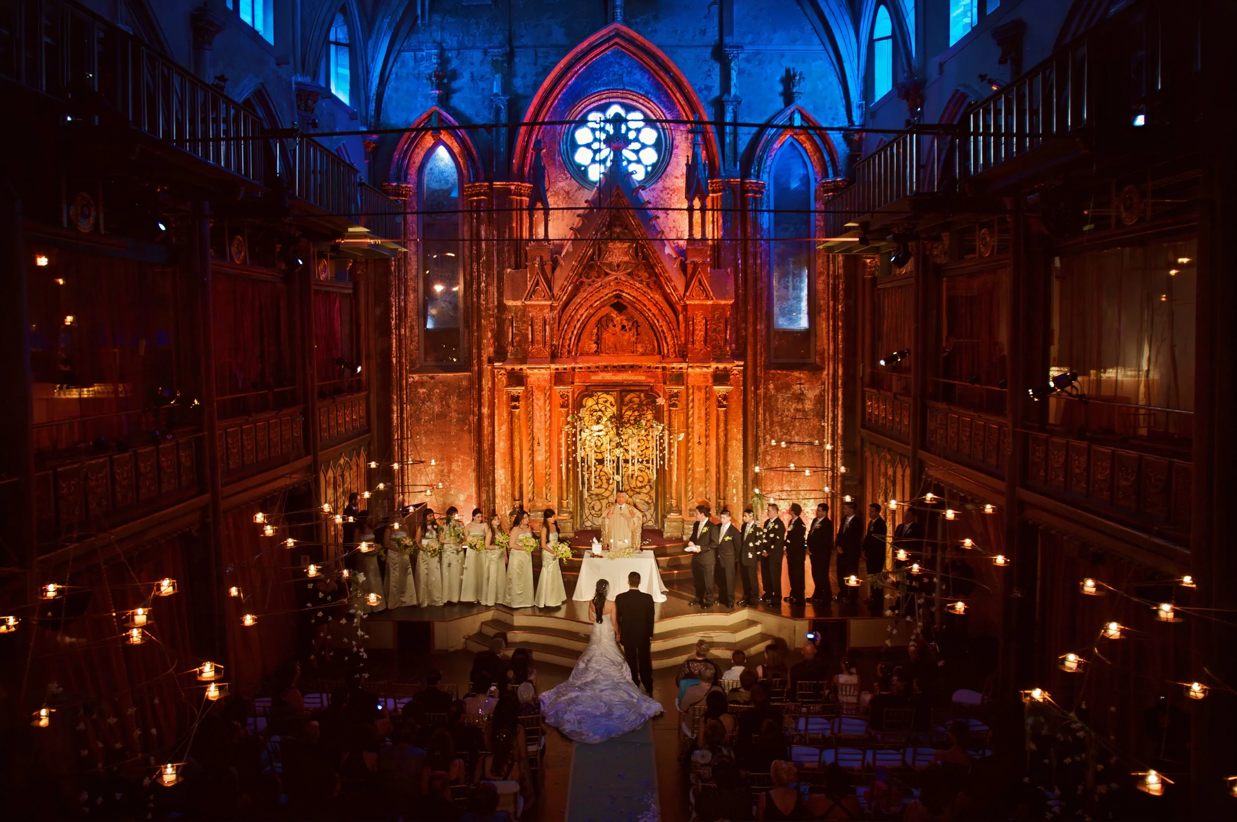 Wide-angle balcony view of a wedding ceremony beneath the grandeur of Angel Orensanz Center in NYC.