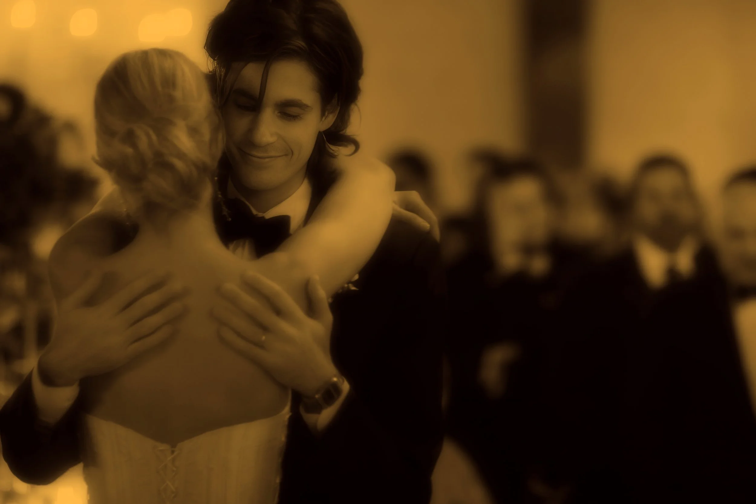 A warm, glowing moment as the couple enjoys their first dance.