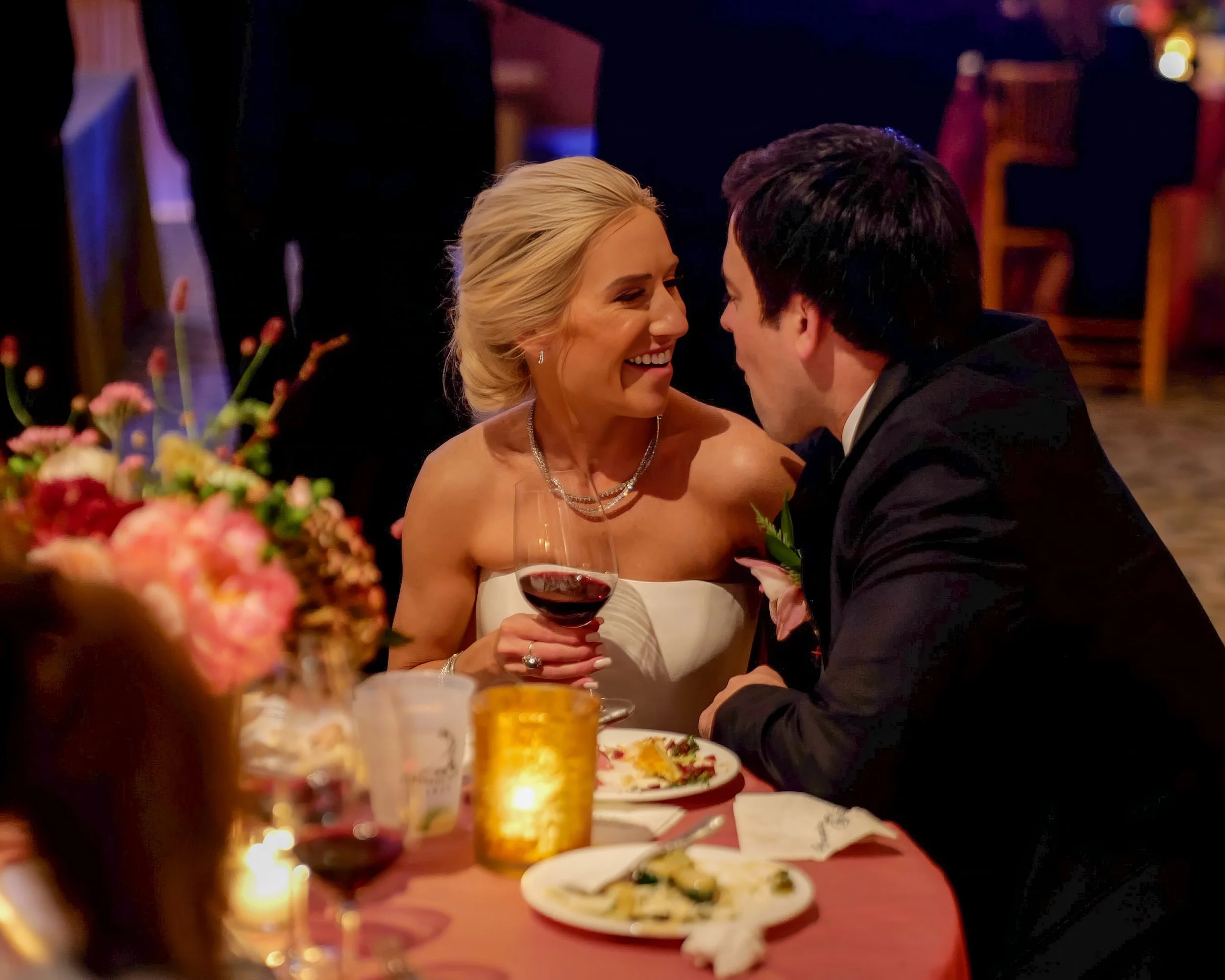 Endearing dinner moment between the bride and groom