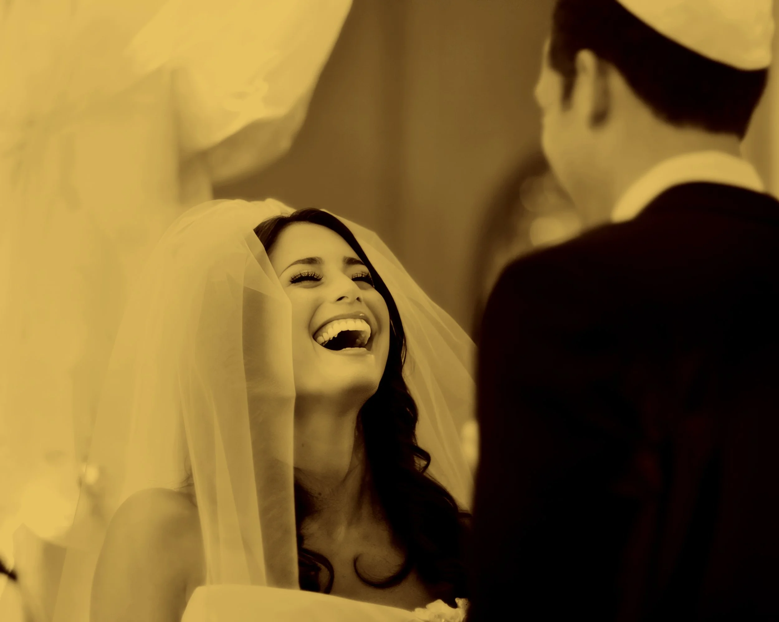 Candid photograph of the bride laughing during her wedding ceremony at The St. Regis New York.