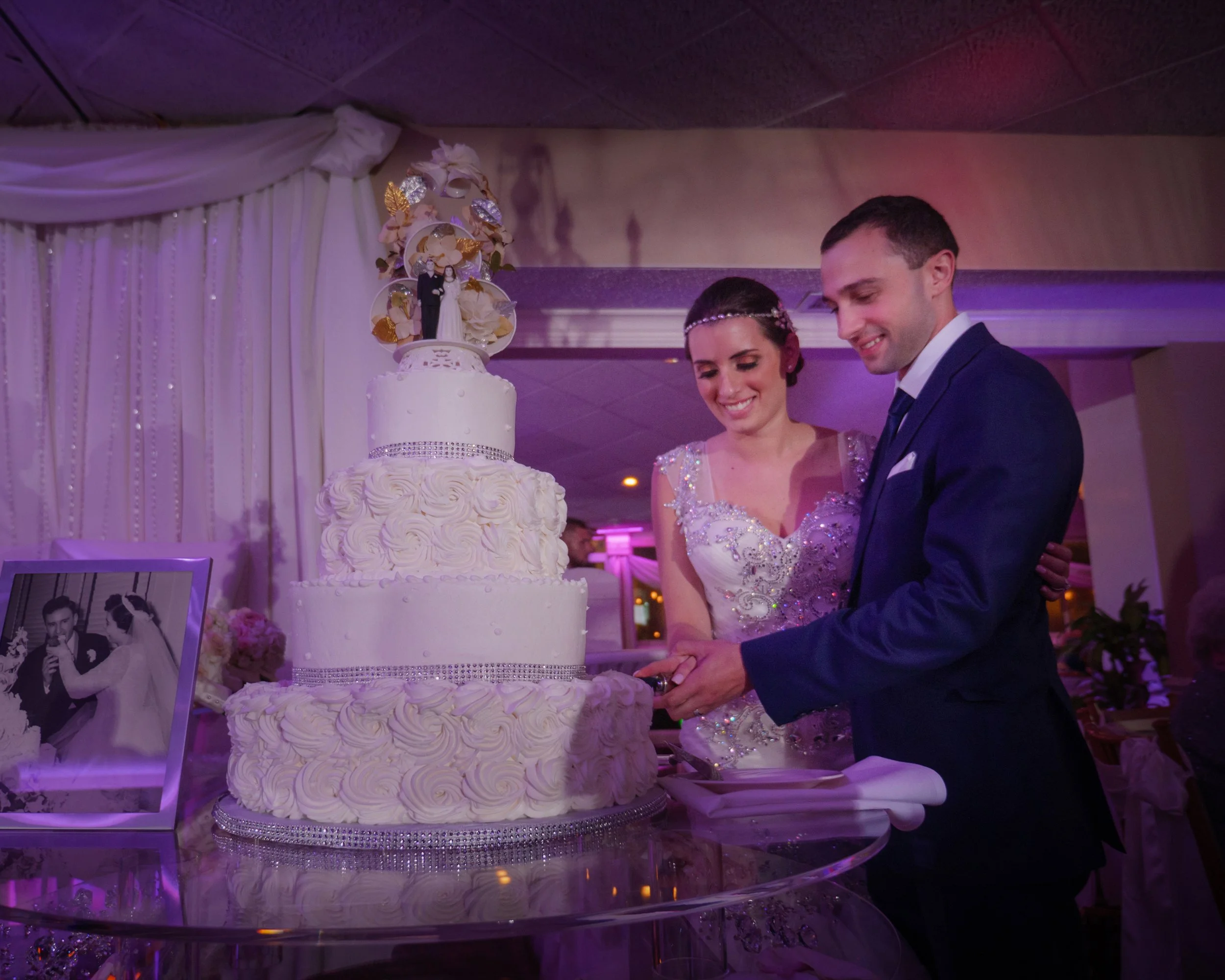 The bride and groom cut their wedding cake at their wedding reception at Anthony's Ocean View New Haven CT