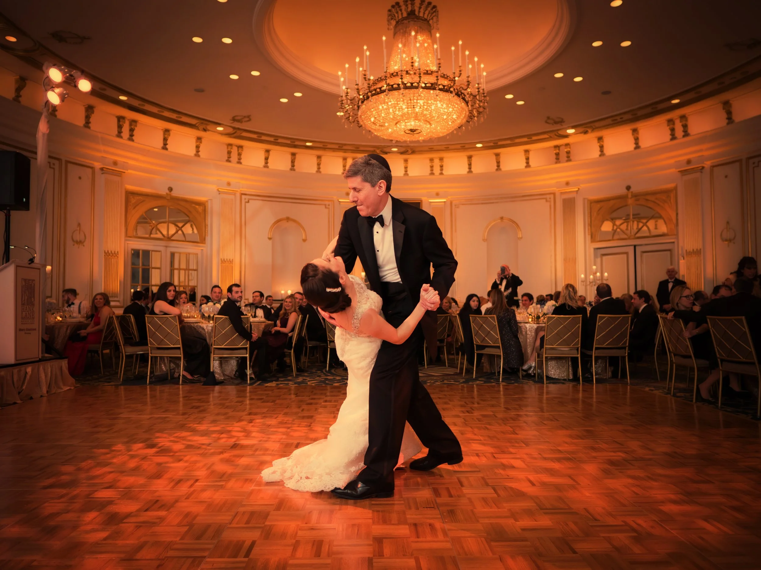Father dipping the bride during a joyful dance inside the Lotte New York Palace ballroom.