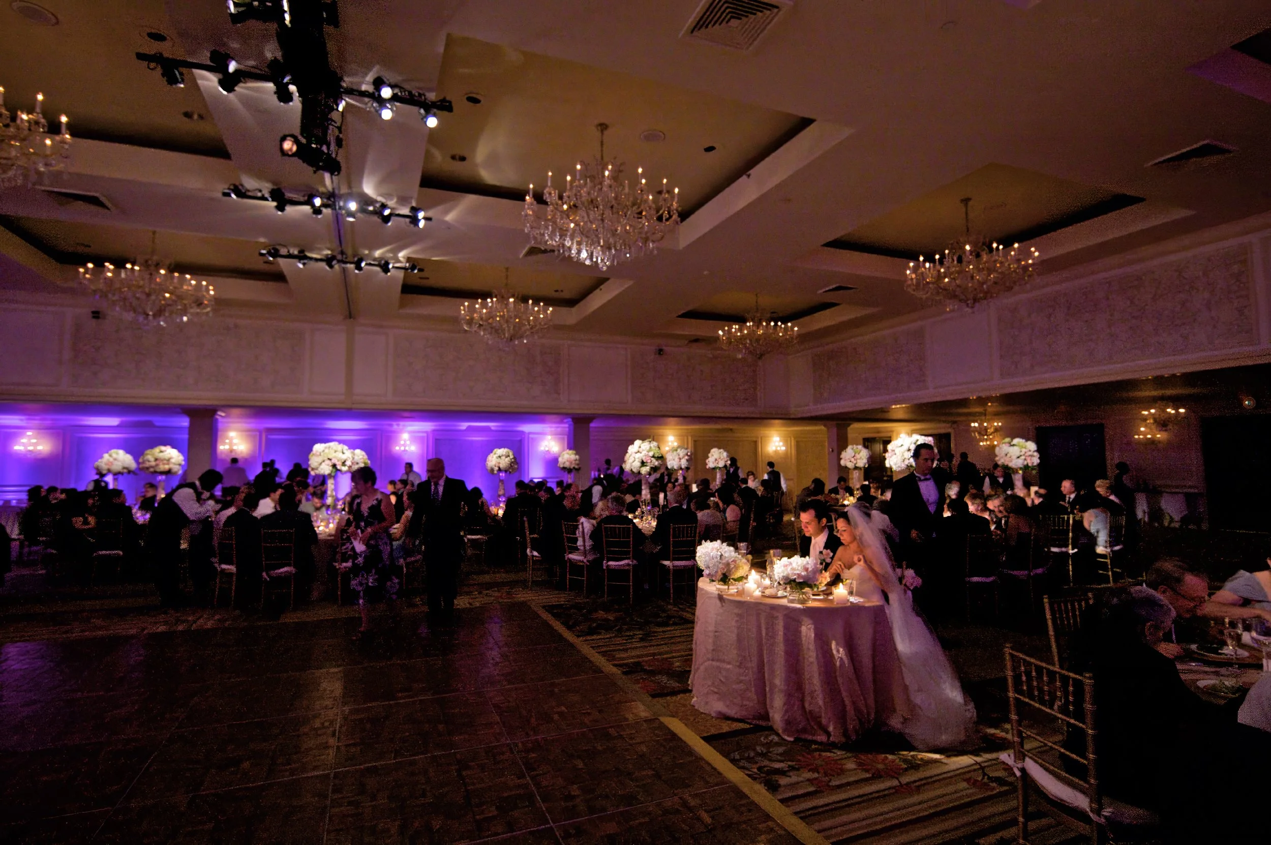 Sweeping view of the bride and groom at their sweetheart table and dinner in the Omni Hotel New Haven ballroom.