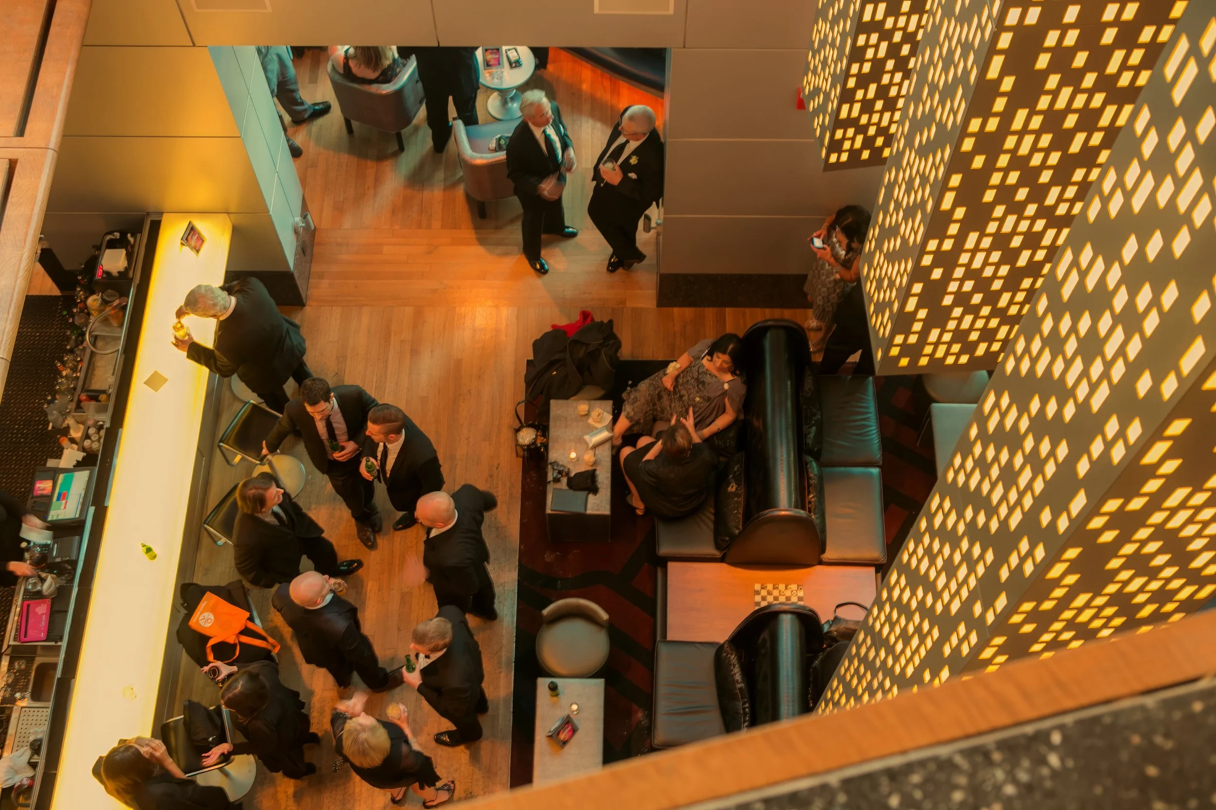 Bird’s-eye view of guests mingling during cocktail hour at W Hoboken wedding reception.