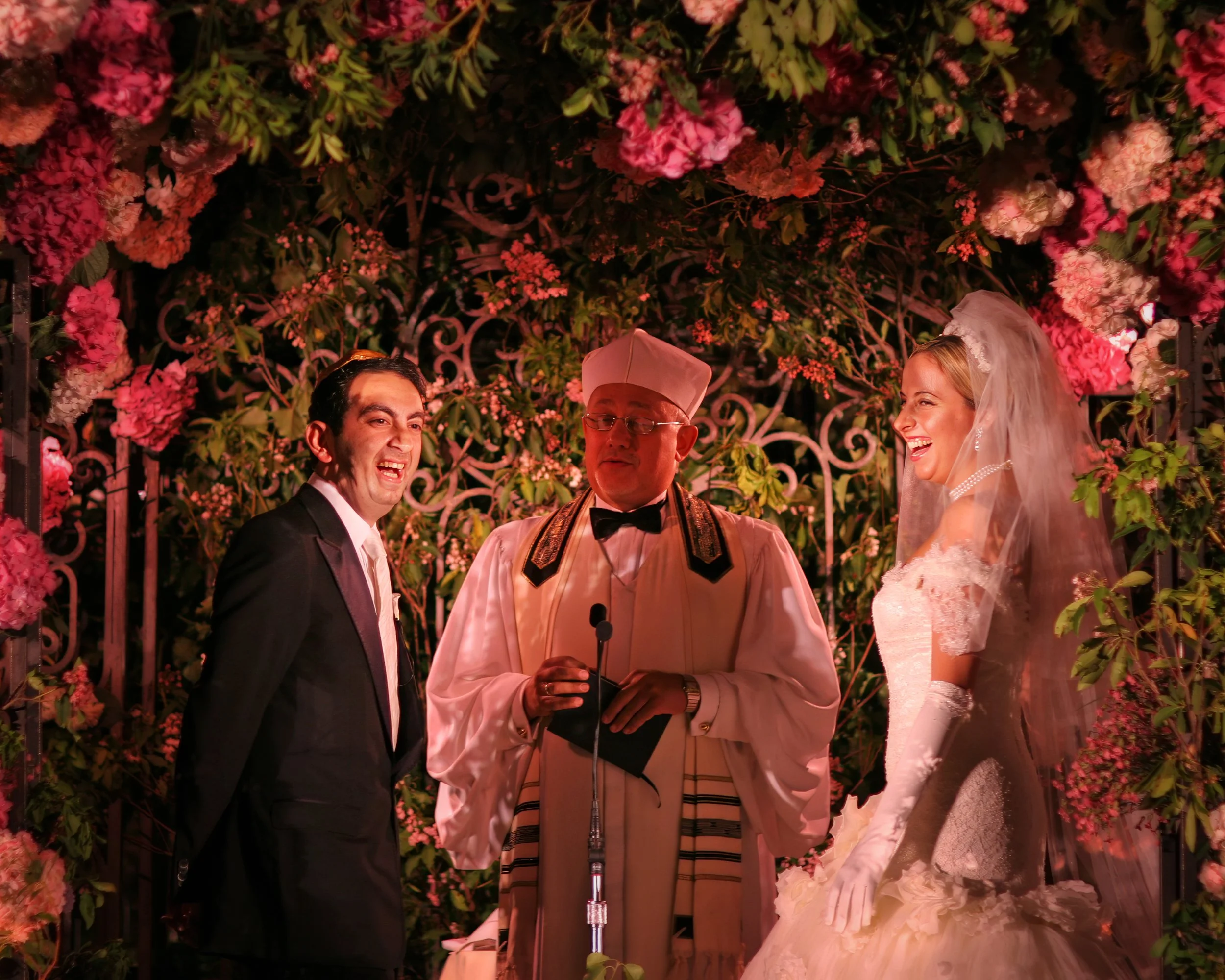 Bride and groom laughing during wedding ceremony at 48 Wall Street in Manhattan.