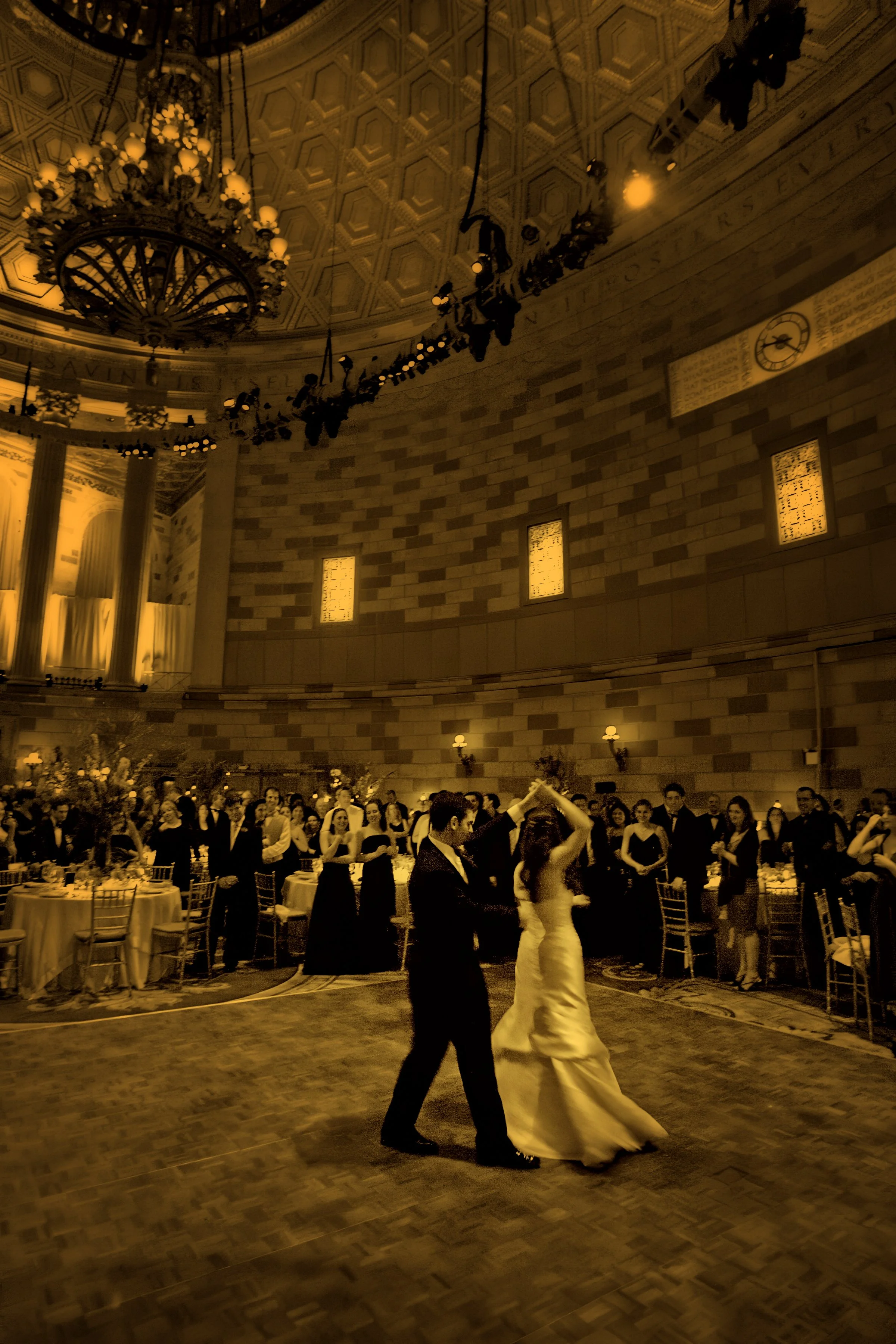 Bride and groom dancing beneath the grand dome of Gotham Hall ballroom, showcasing the venue’s architectural splendor.