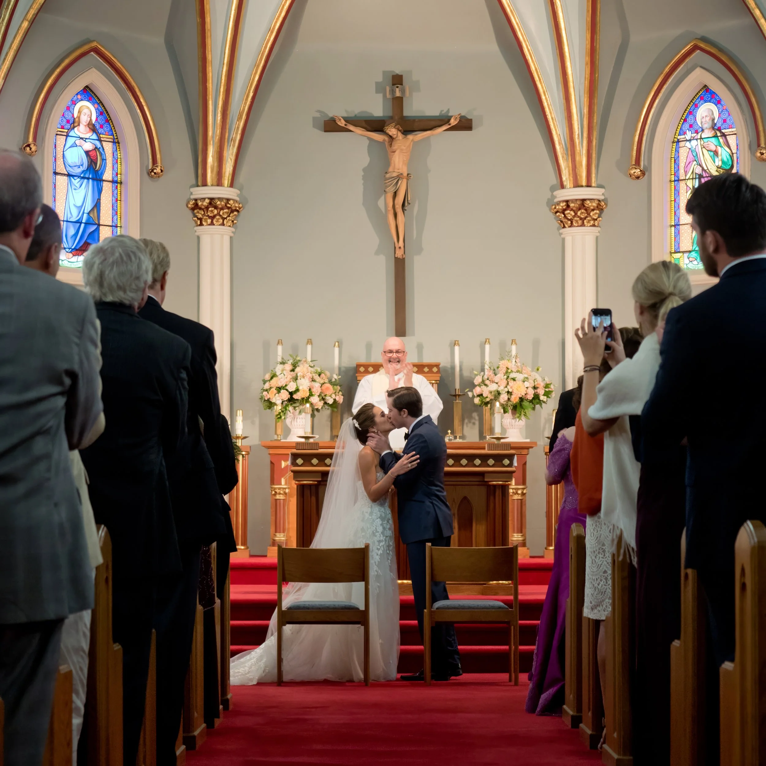Bride and groom sharing their first kiss as husband and wife at Saint Mary’s Church in Sharon Connecticut.