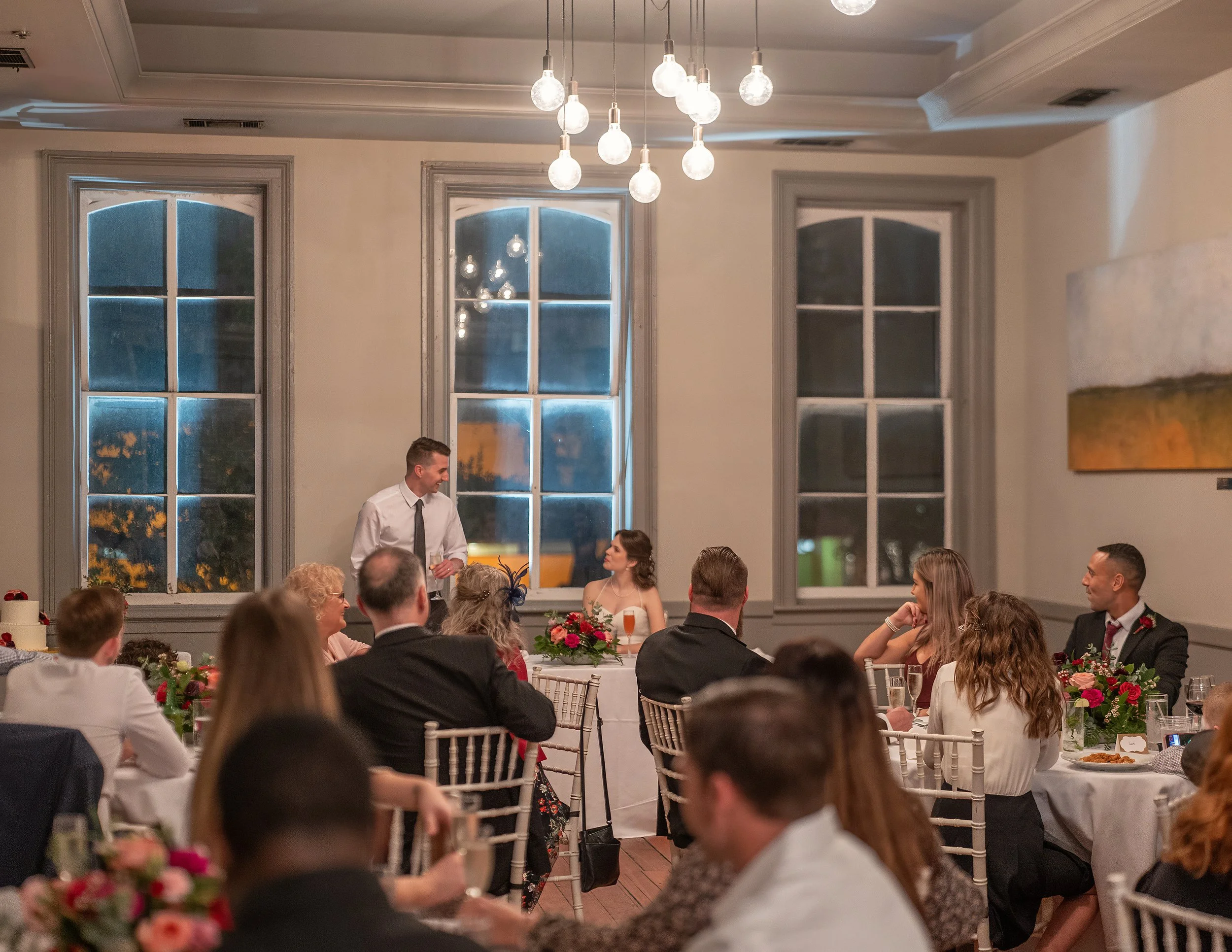 Tim raises a toast to Daniella as family and friends look on during their wedding reception at Churchill’s in Savannah.