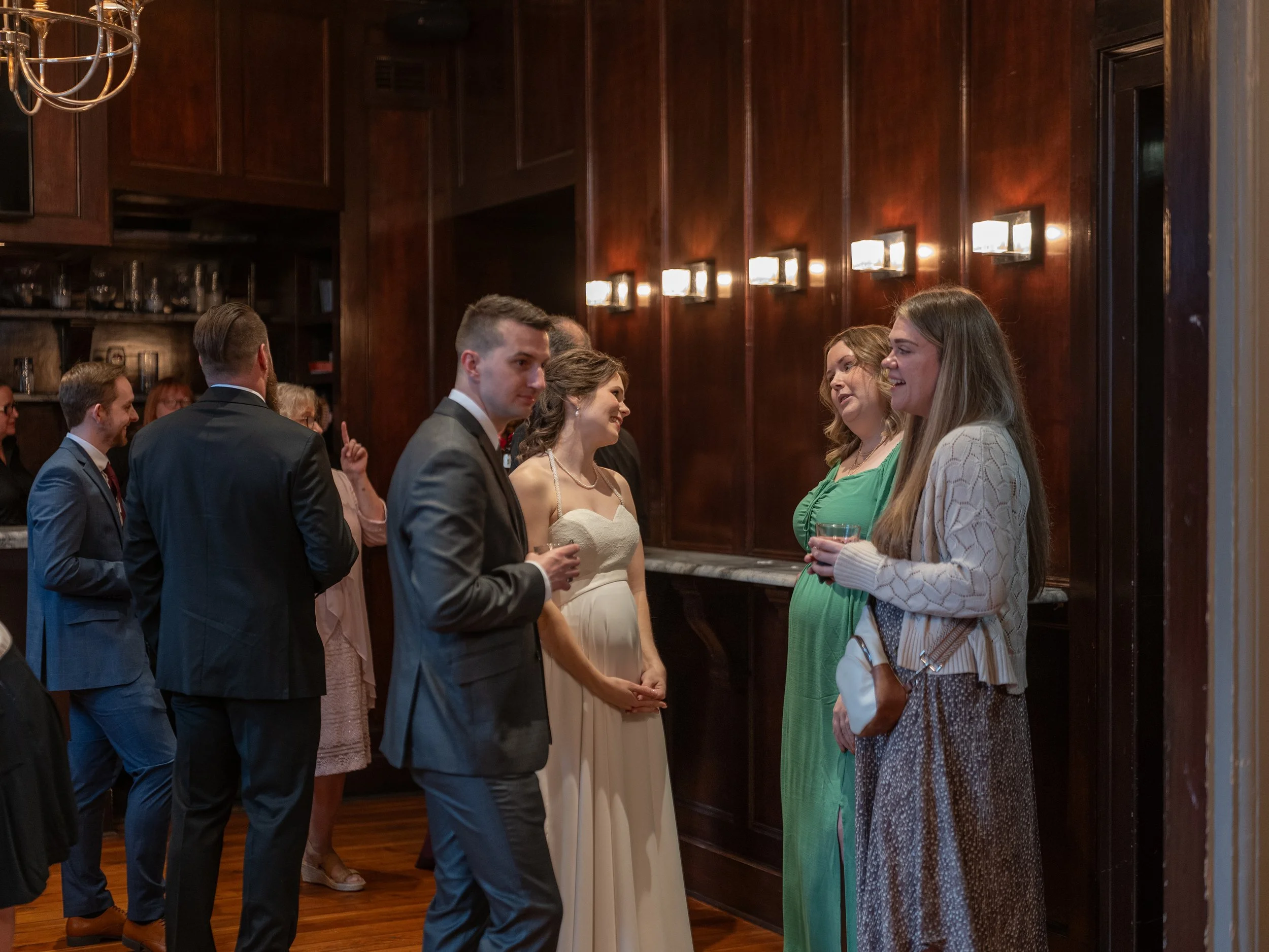 Daniella and Tim visit with family and friends during cocktail hour at Churchill’s following her Savannah micro wedding ceremony.