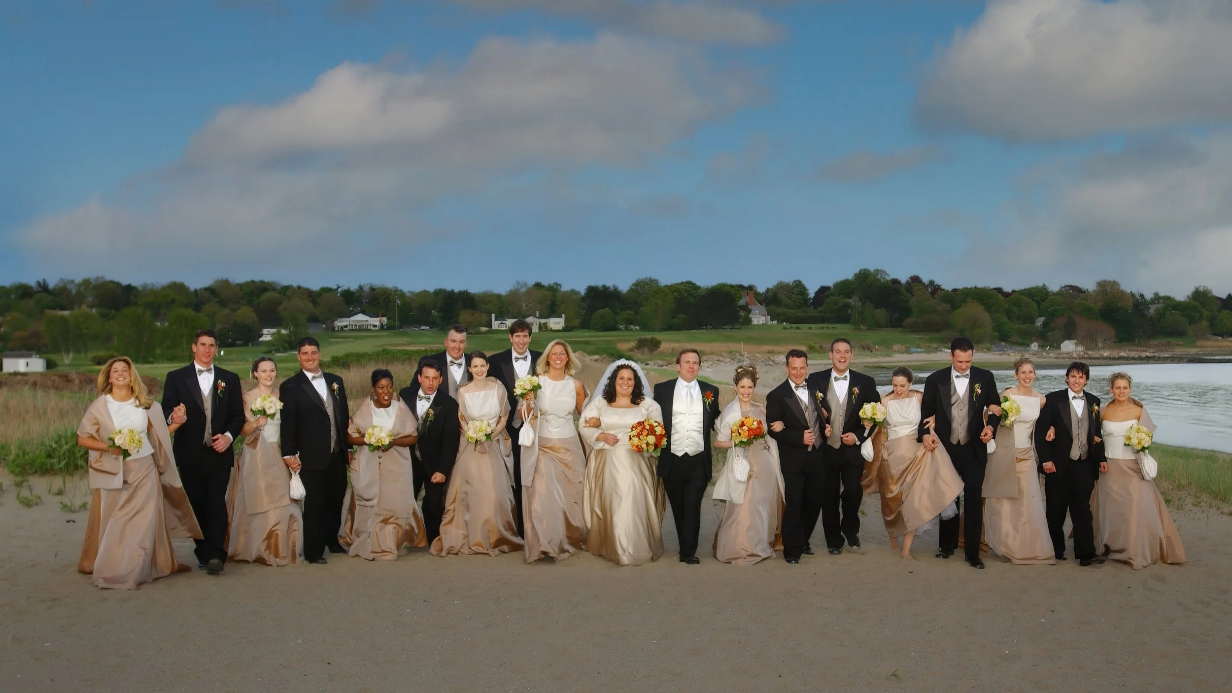 Wedding party walking along the beach in Southport, Connecticut.