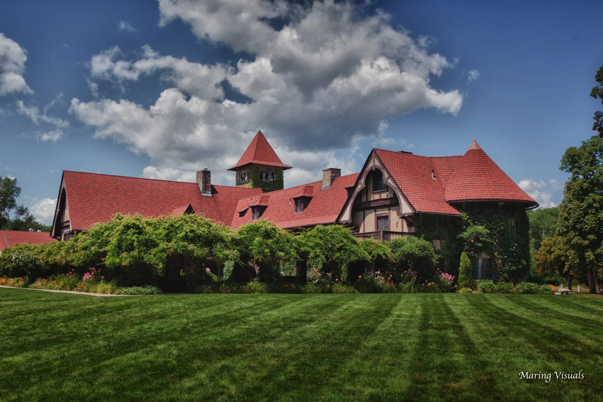 Colorful summer exterior of Saint Clements Castle in Portland, Connecticut framed by a vibrant blue sky.