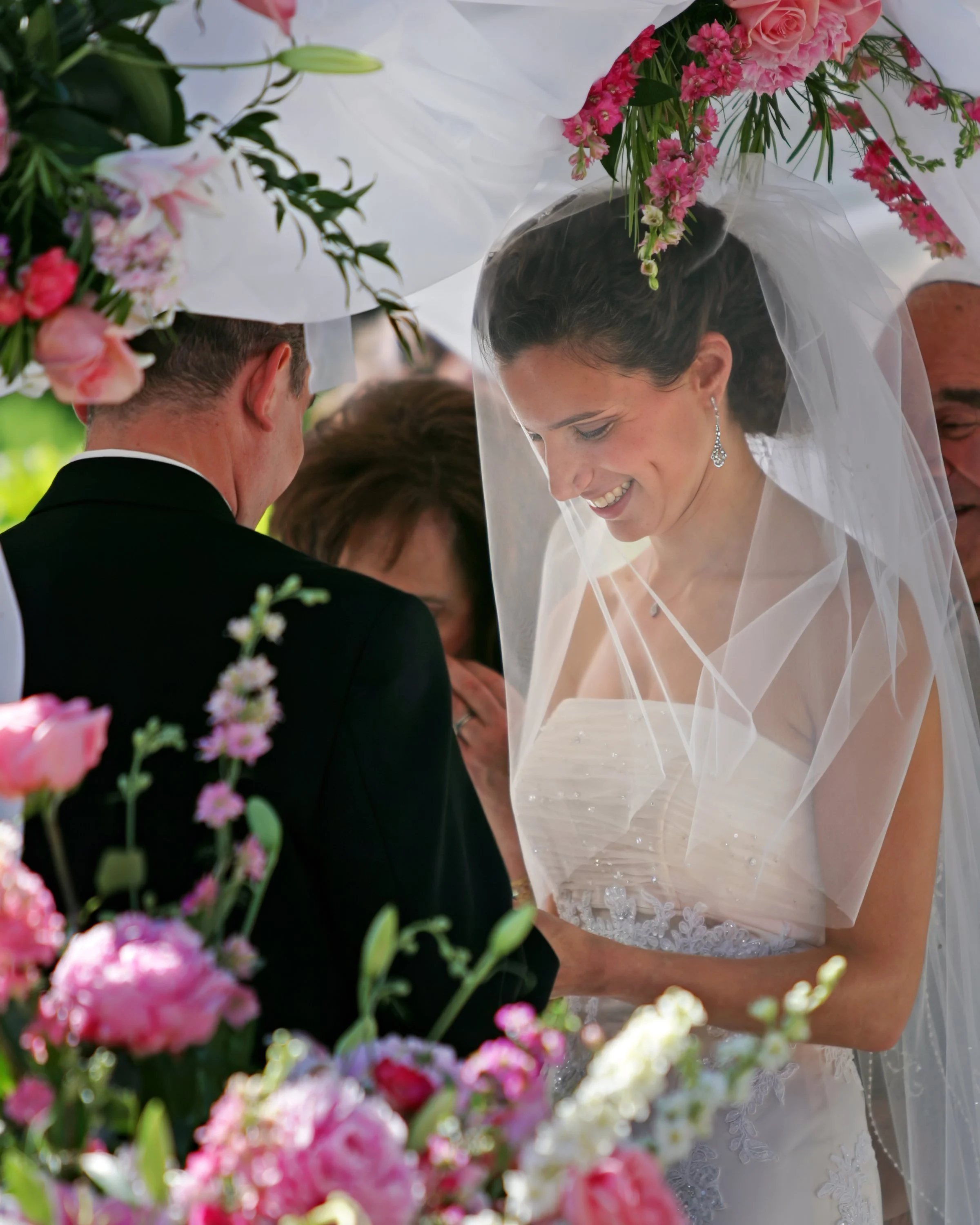 Bride and groom exchanging rings during outdoor wedding ceremony at Spa at Norwich Inn Connecticut