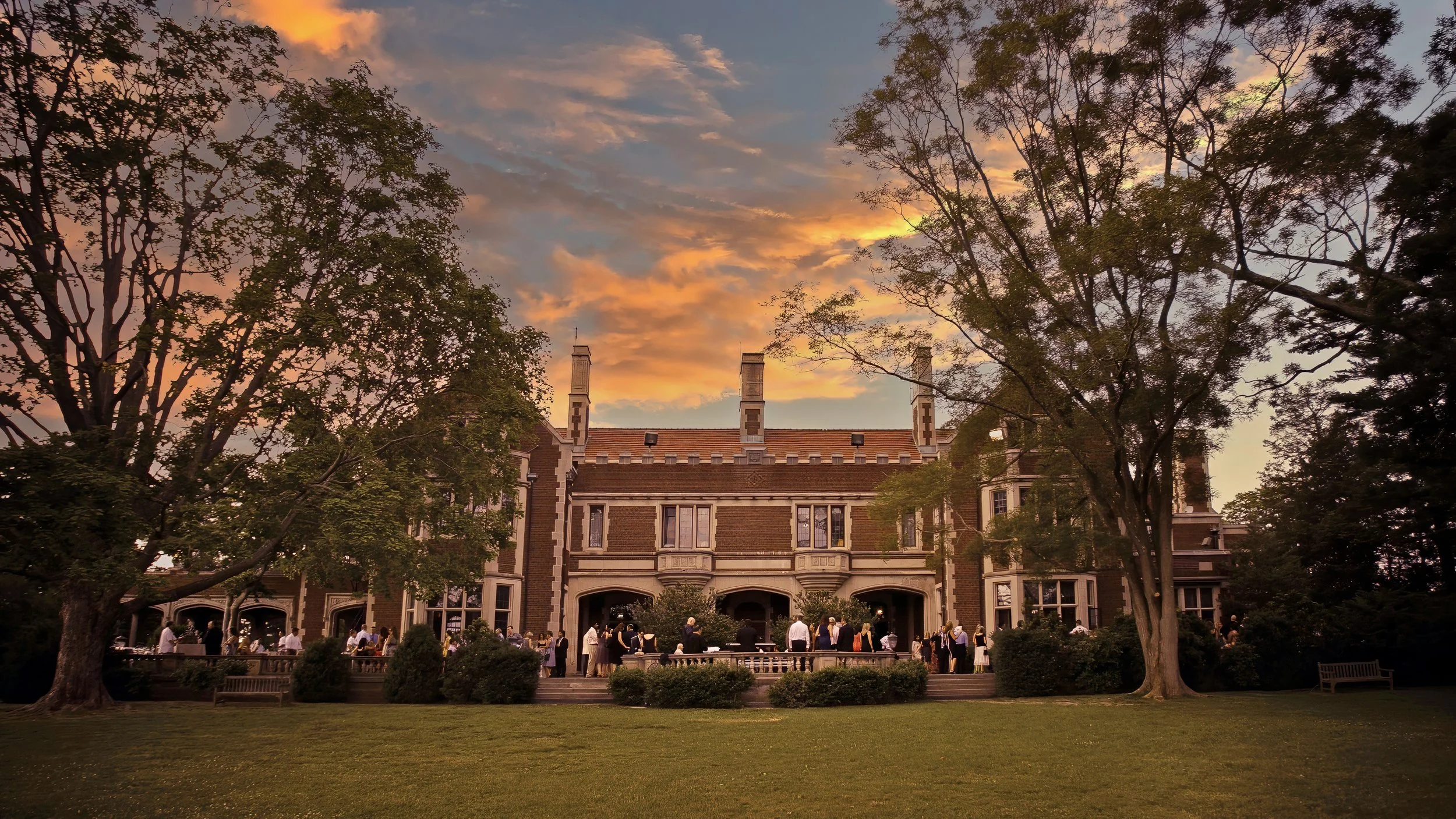 Sweeping exterior view of a cocktail hour at Waveny House in New Canaan, Connecticut.