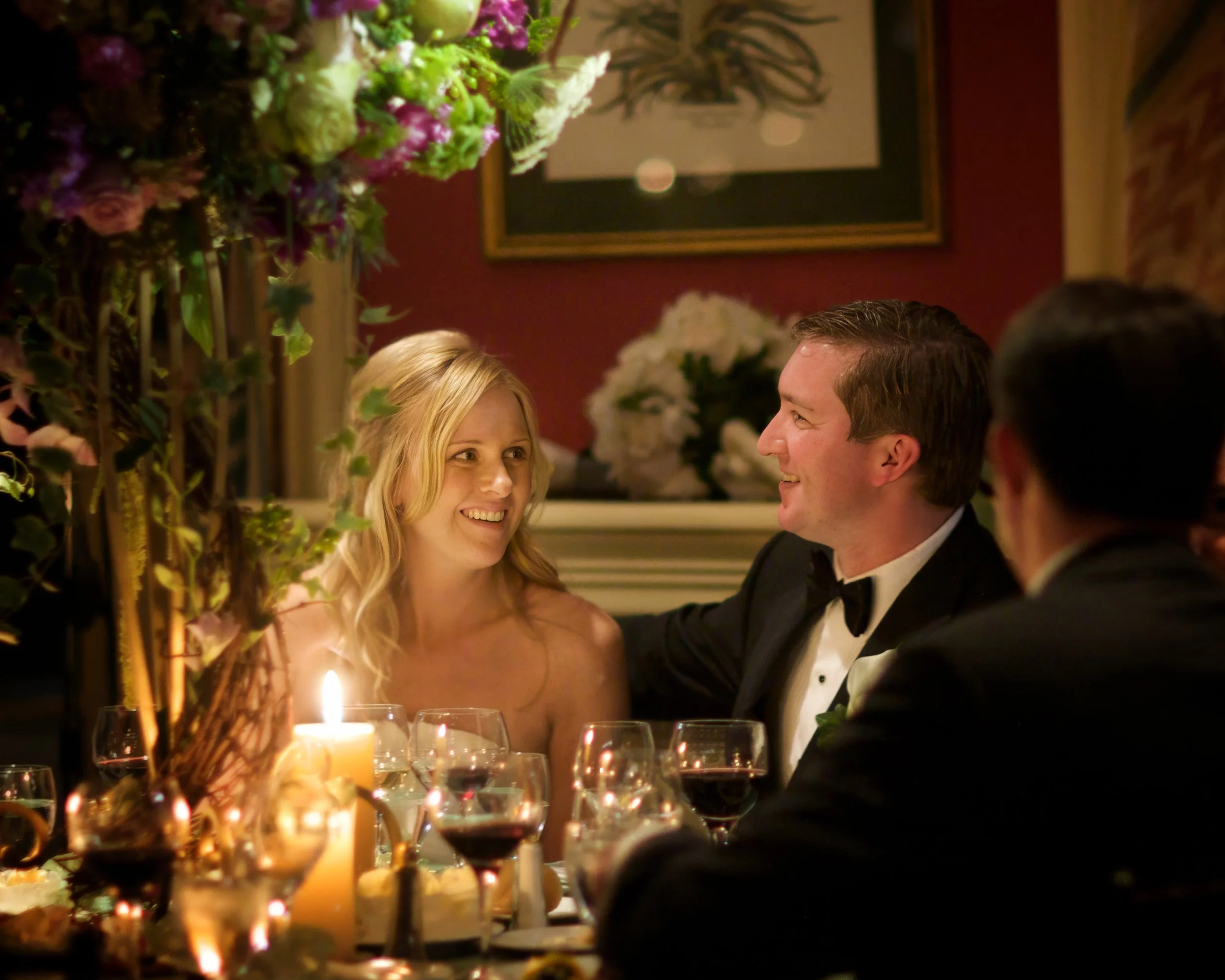 Bride and groom share joyful dinner conversation during their reception at Siwanoy Country Club.