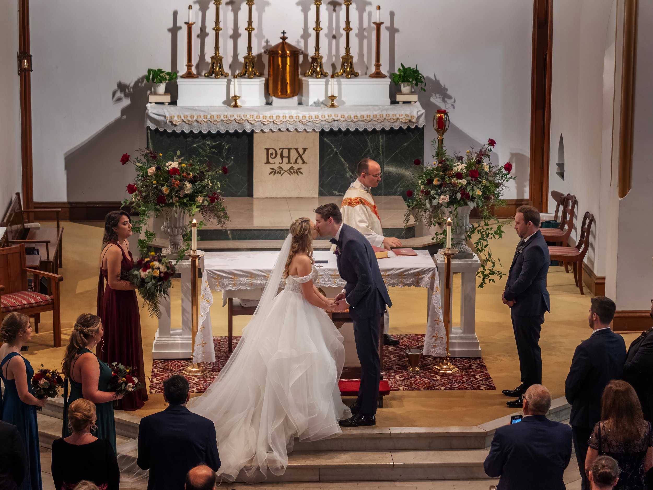 First kiss at Sacred Heart Catholic Church prior to a wedding reception at Savannah Station