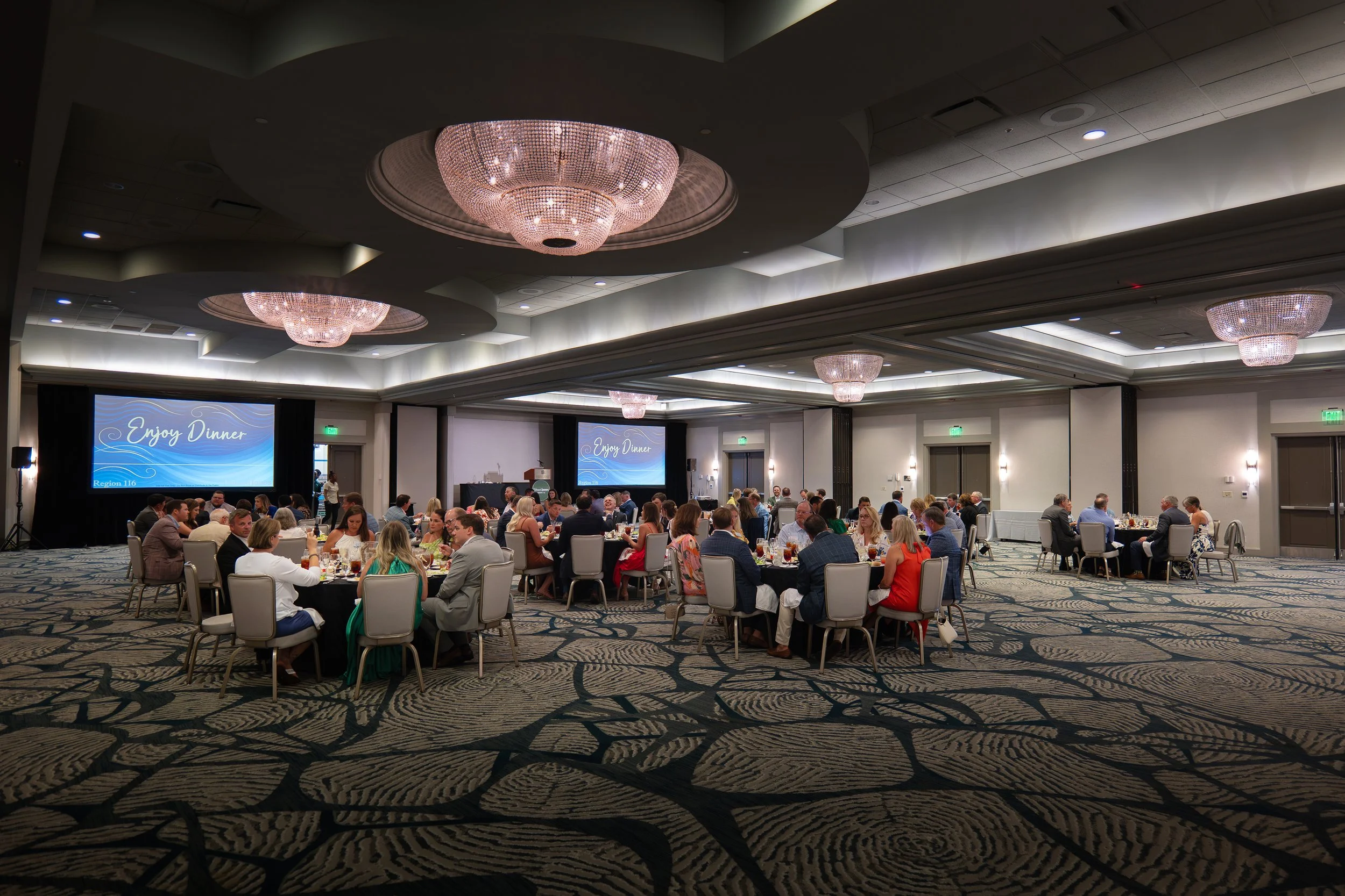 Wide ballroom view of attendees enjoying dinner during a corporate event at Sonesta Resort Hilton Head.