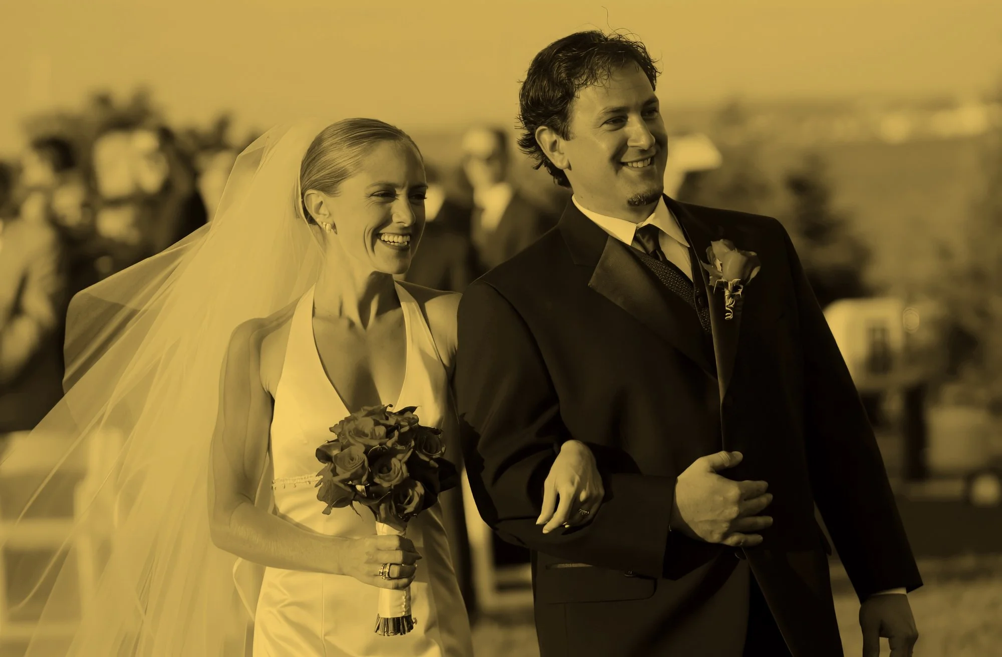Bride and groom walking down the aisle during ceremony recessional at Castle Hill, full of joy.
