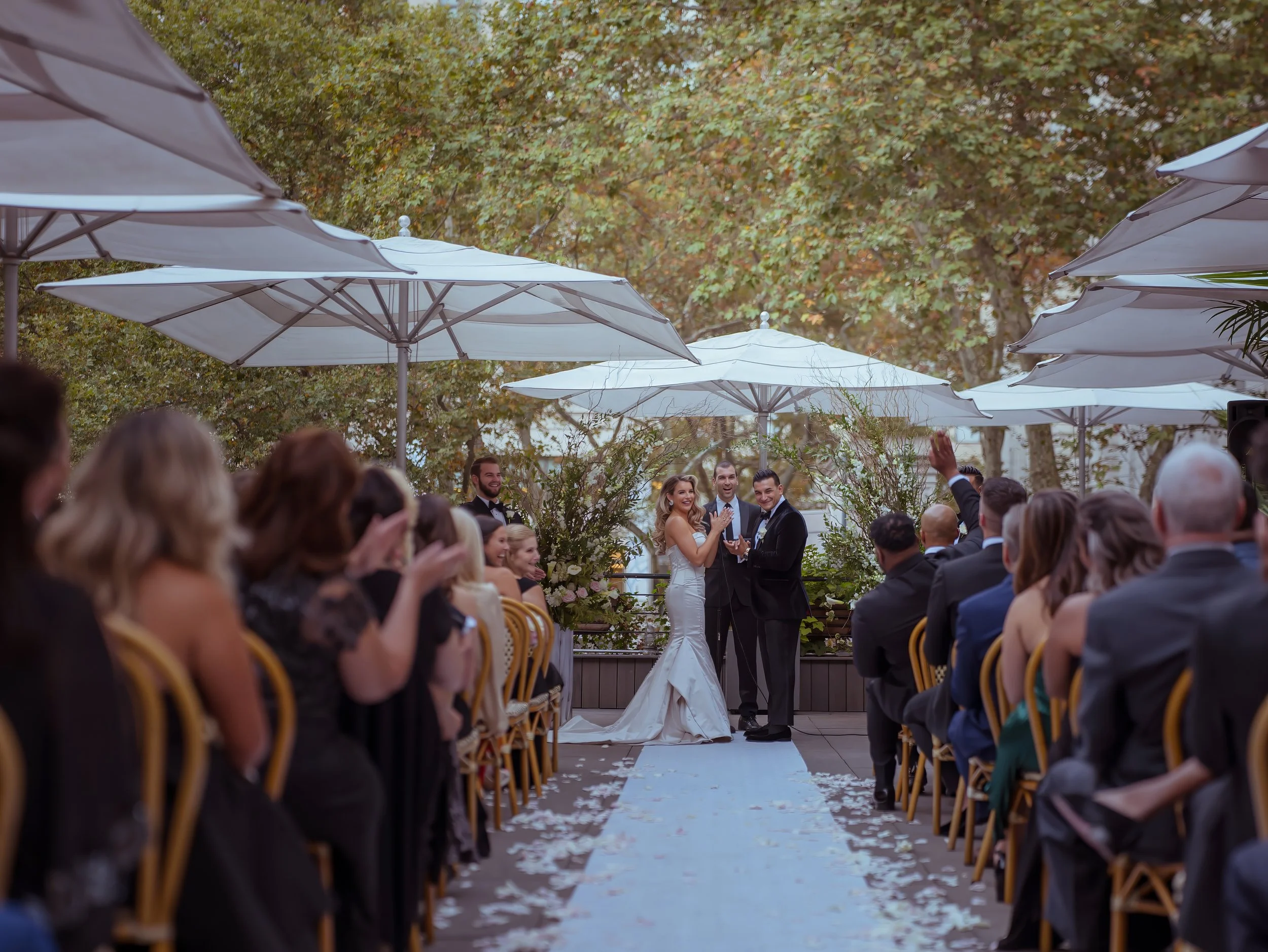 Bride and groom joyful candid moment during wedding ceremony on the terrace at Bryant Park Grill Midtown Manhattan