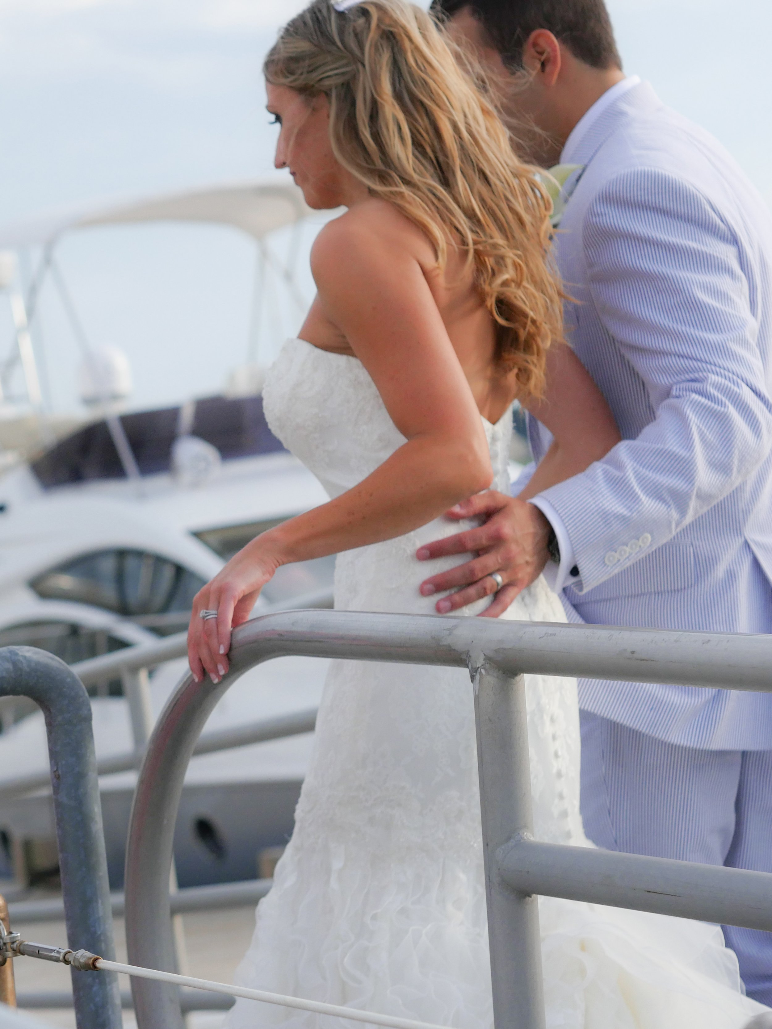 Groom escorts the bride along the private docks at Delamar Greenwich Harbor.