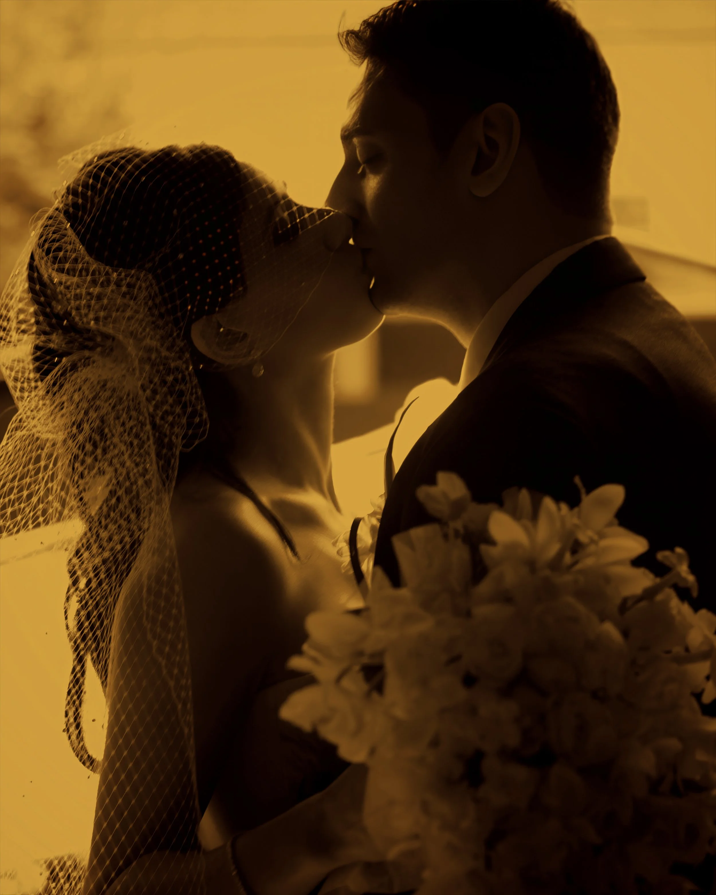 Fine art silhouette of a bride and groom kissing in a doorway at Angel Orensanz.