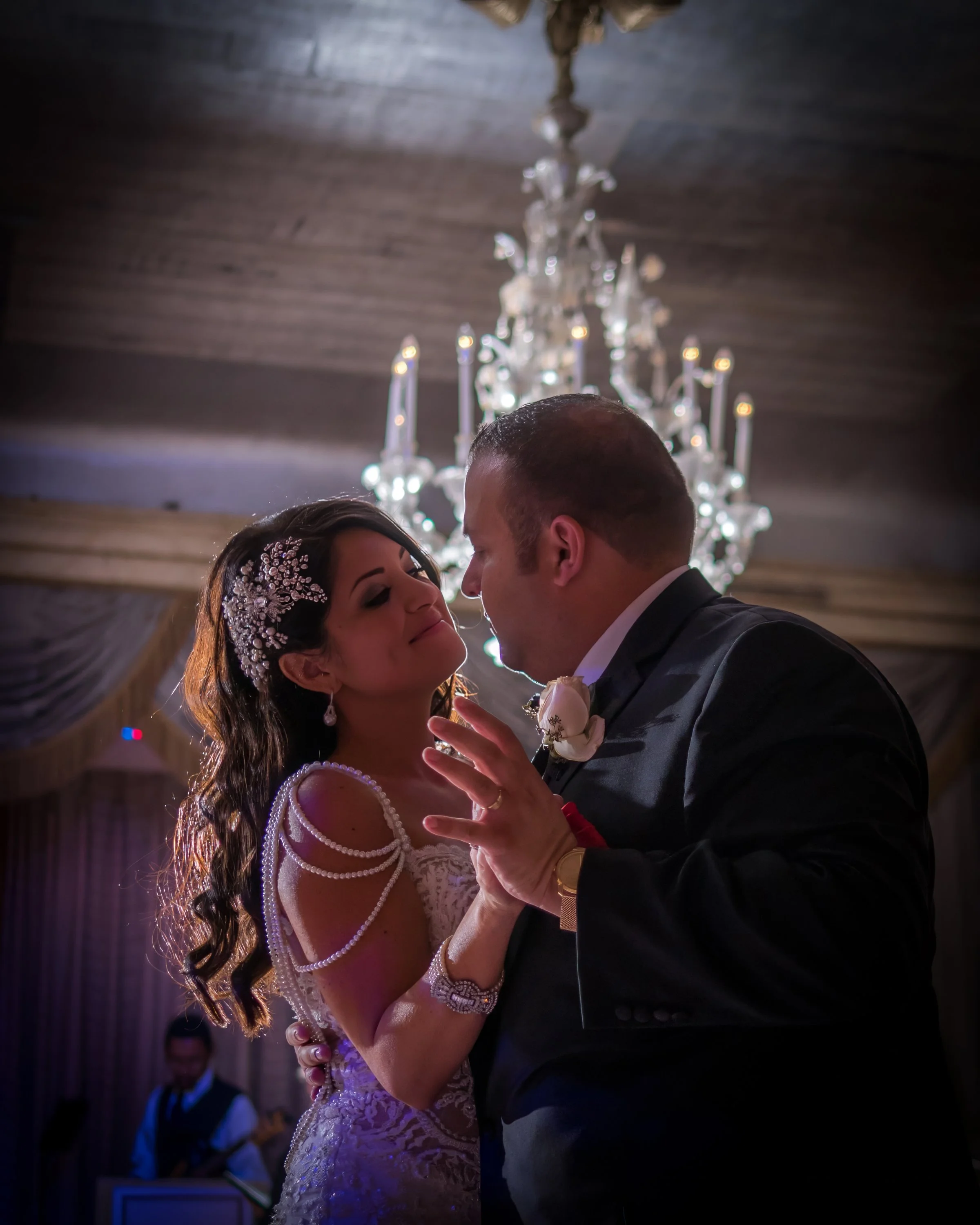 Bride and groom sharing their first dance in the elegant ballroom at The Pierre Hotel wedding reception in New York.